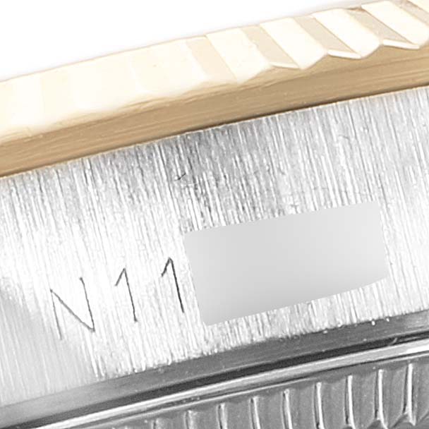This image shows a close-up of the side casing and fluted bezel of a Rolex Oyster Perpetual 67193 Women
s Steel and Gold (two tone) Champagne Dial 67193 Women
s Steel and Gold (two tone) Champagne Dial watch.
