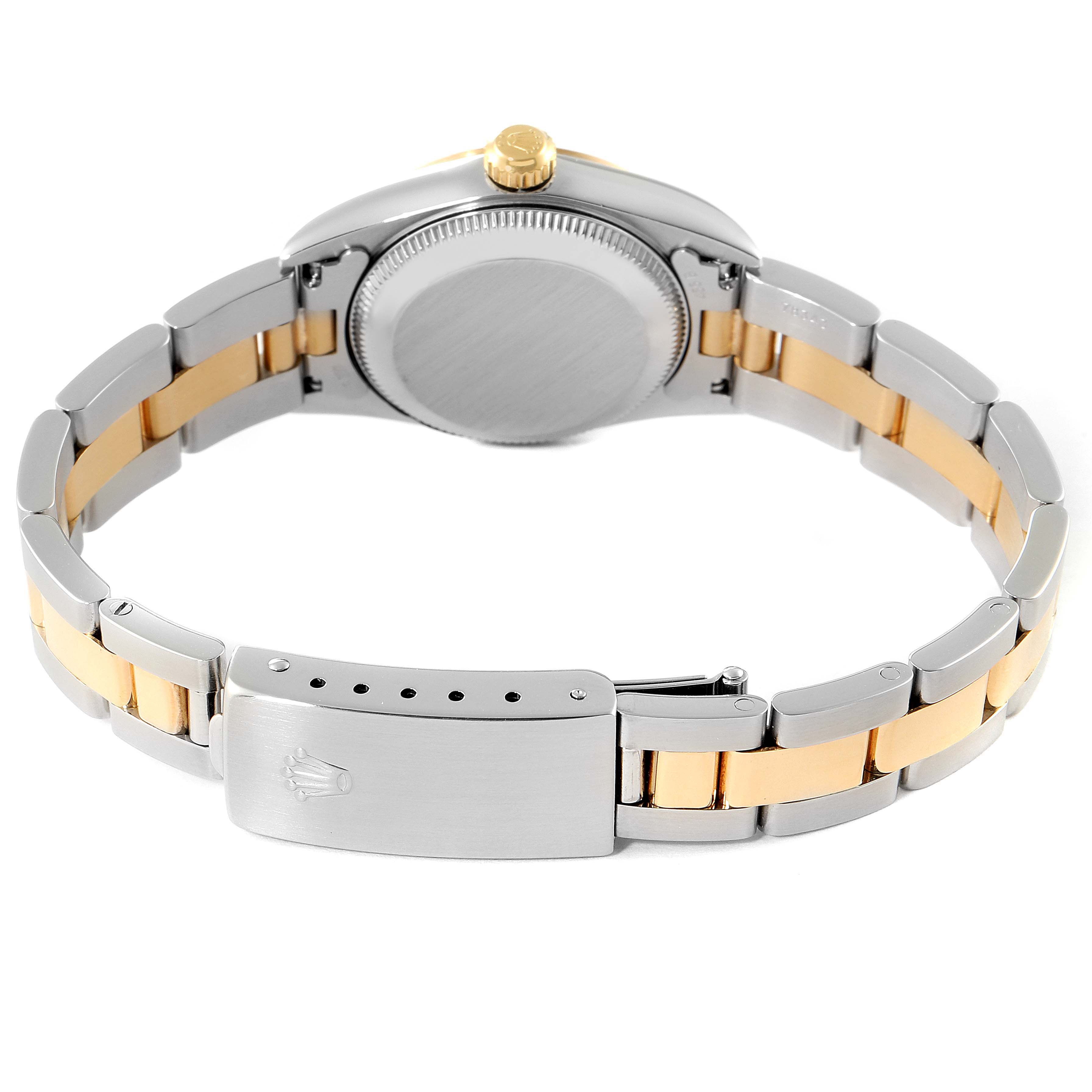 The image shows the back view of a Rolex Oyster Perpetual 76183 Women
s Steel and Gold (two tone) White Dial 76183 Women
s Steel and Gold (two tone) White Dial watch with a silver and gold bracelet.