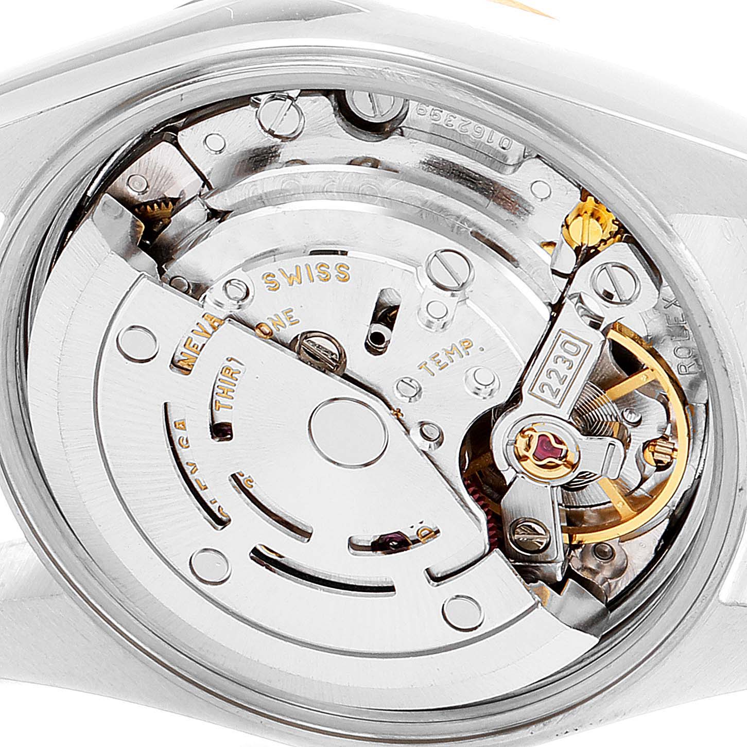 The image shows the movement and inner workings of a Rolex Oyster Perpetual 76183 Women
s Steel and Gold (two tone) White Dial 76183 Women
s Steel and Gold (two tone) White Dial watch from a close-up angle.