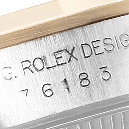 The image shows a close-up of the side engravings on the bezel of a Rolex Oyster Perpetual 76183 Women
s Steel and Gold (two tone) White Dial 76183 Women
s Steel and Gold (two tone) White Dial watch.