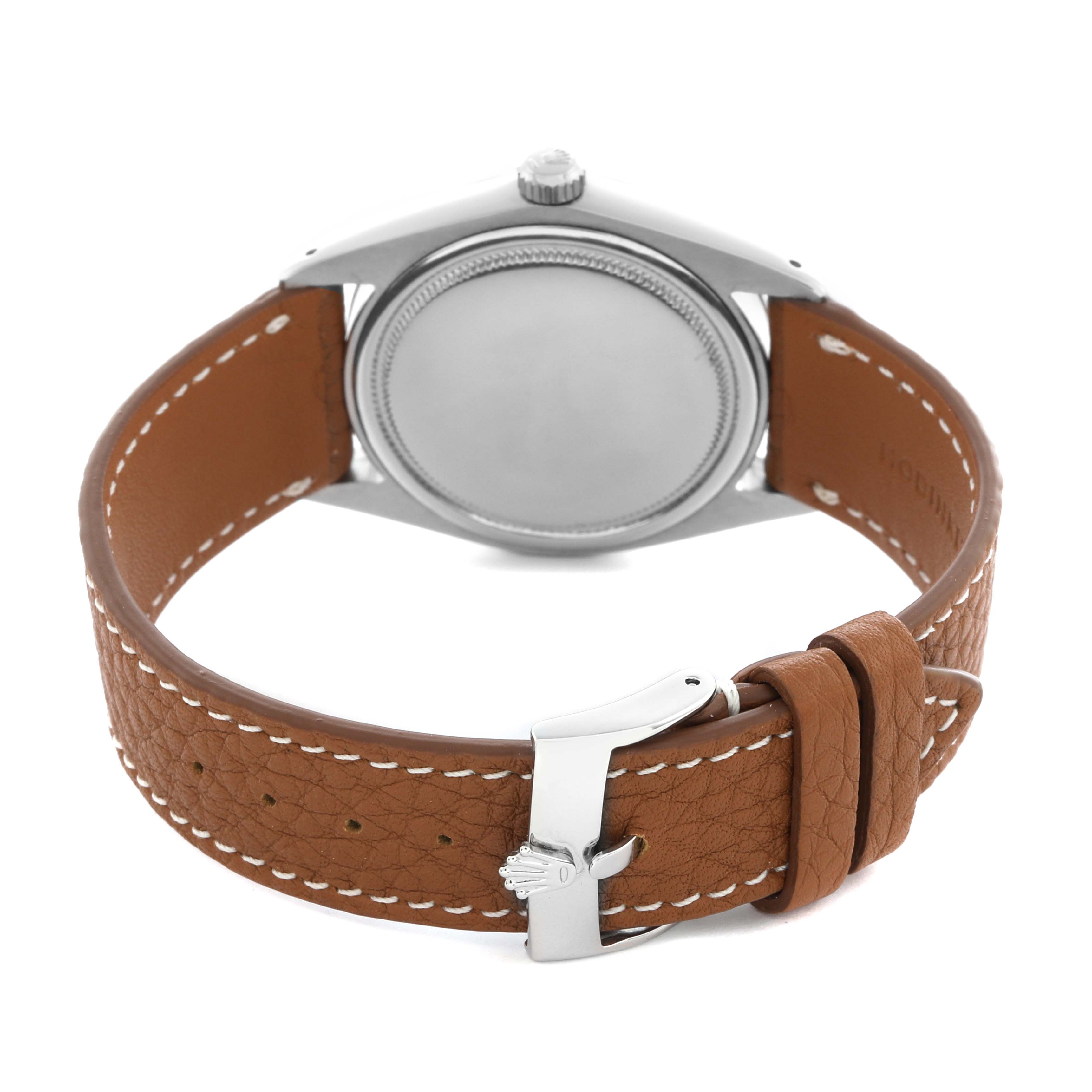 The Vintage Collection Rolex watch is shown from the back, featuring the case back, crown, and a brown leather strap with a clasp.