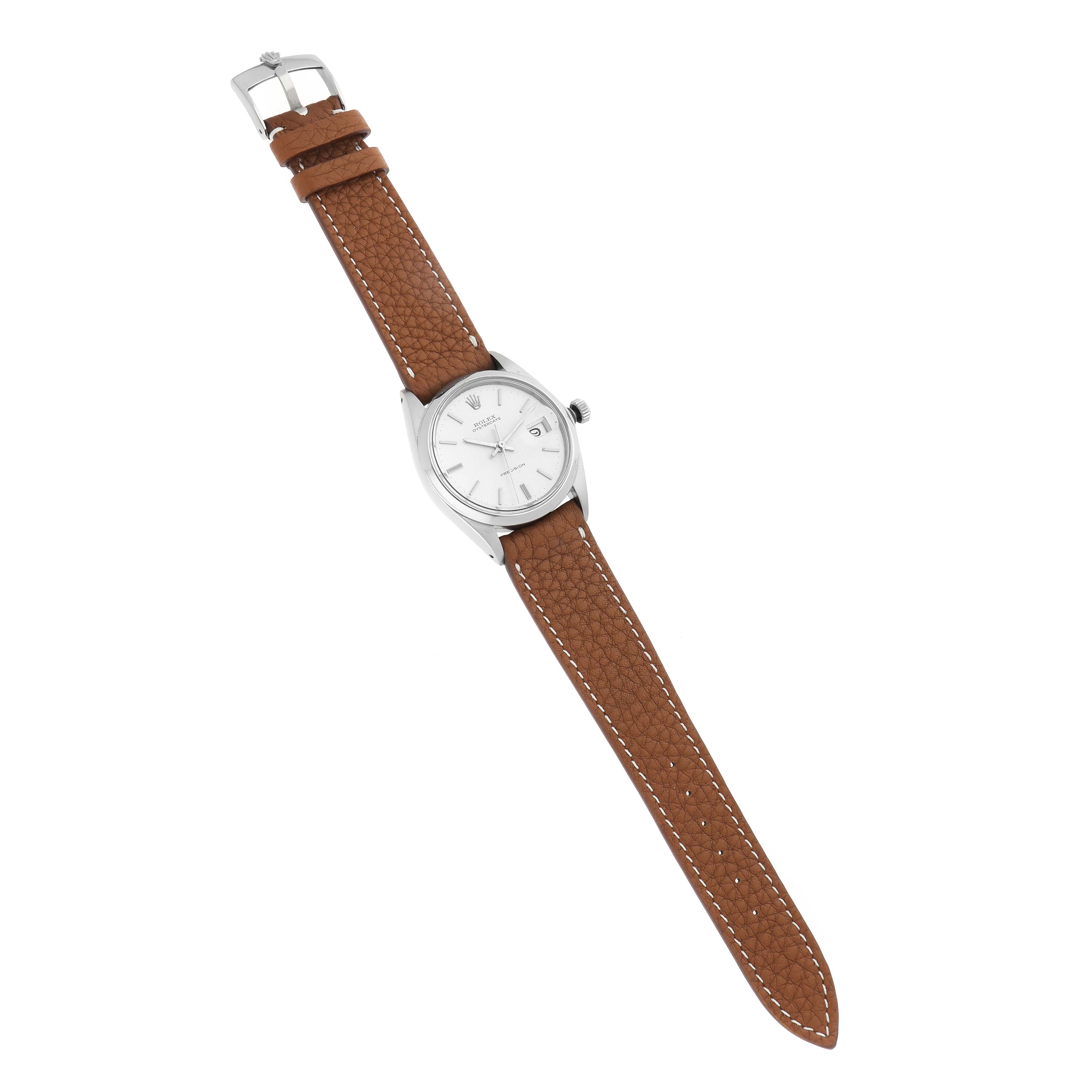 The Rolex Vintage Collection 6694 Men
s Stainless Steel Silver Dial 6694 Men
s Stainless Steel Silver Dial watch is shown at a top-down angle, displaying its face, dial, brown leather strap, and buckle.