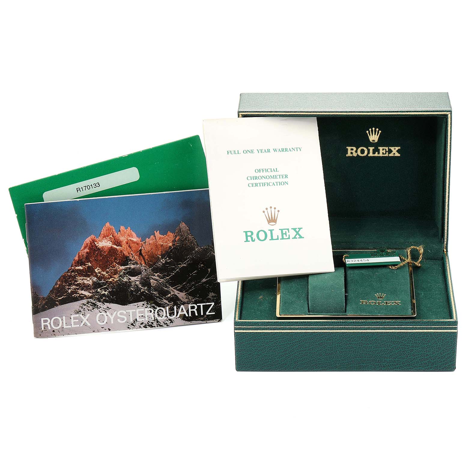 This image shows the accessories of a Rolex Oysterquartz 17013 Men
s Steel and Gold (two tone) Champagne Dial 17013 Men
s Steel and Gold (two tone) Champagne Dial watch, including the warranty card, manual, and green box.