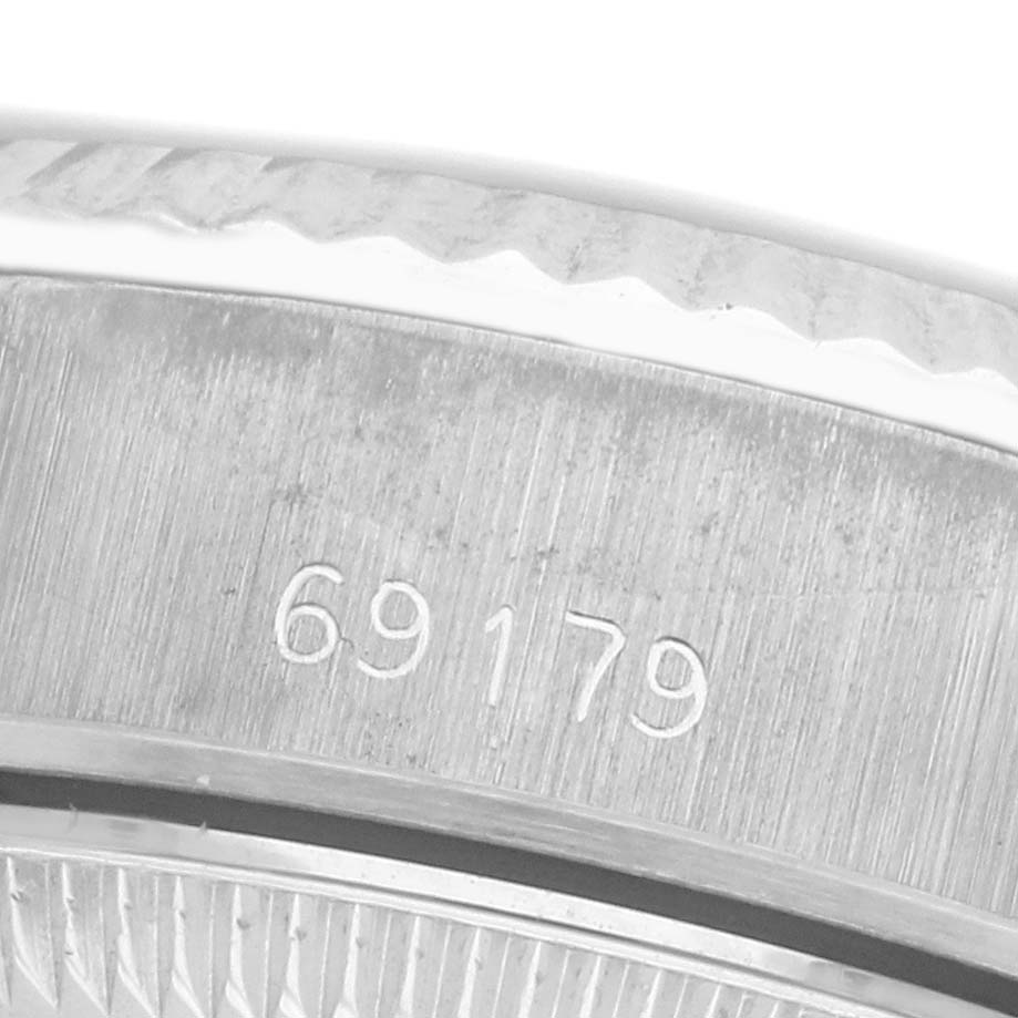 The image shows a close-up of the serial number engraving on the side of a Rolex President 69179 Women
s White Gold White Dial 69179 Women
s White Gold White Dial watch case.
