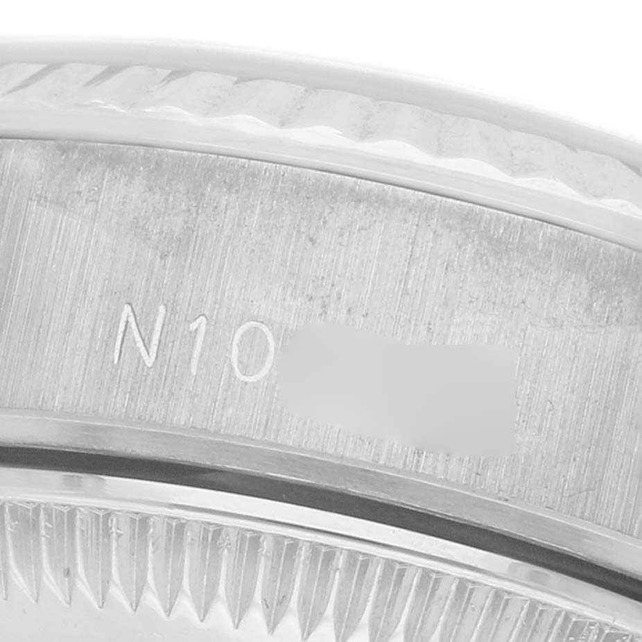 The image shows a close-up of the bezel and part of the case of the Rolex President 69179 Women
s White Gold White Dial 69179 Women
s White Gold White Dial model, focusing on serial engravings.