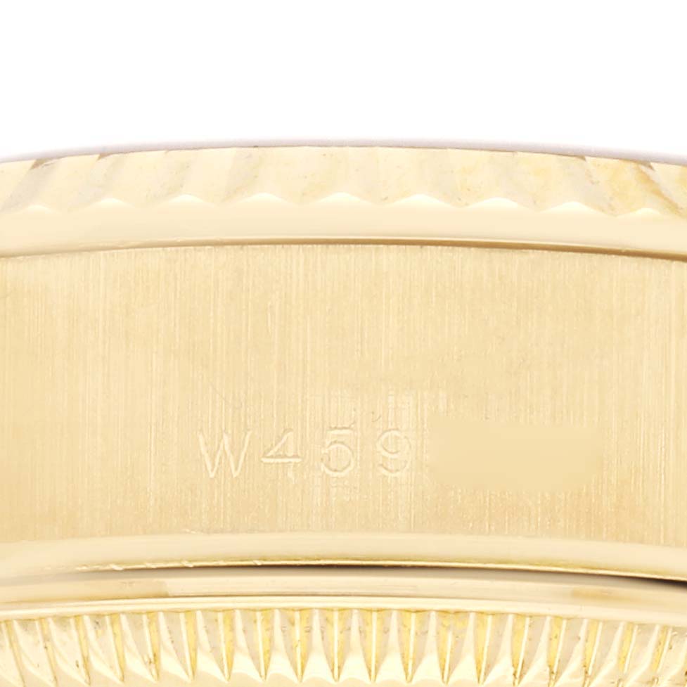 The image shows the side of a Rolex President 69178 Women
s Yellow Gold Champagne Dial 69178 Women
s Yellow Gold Champagne Dial model watch, focusing on the serial number area beneath the bezel.