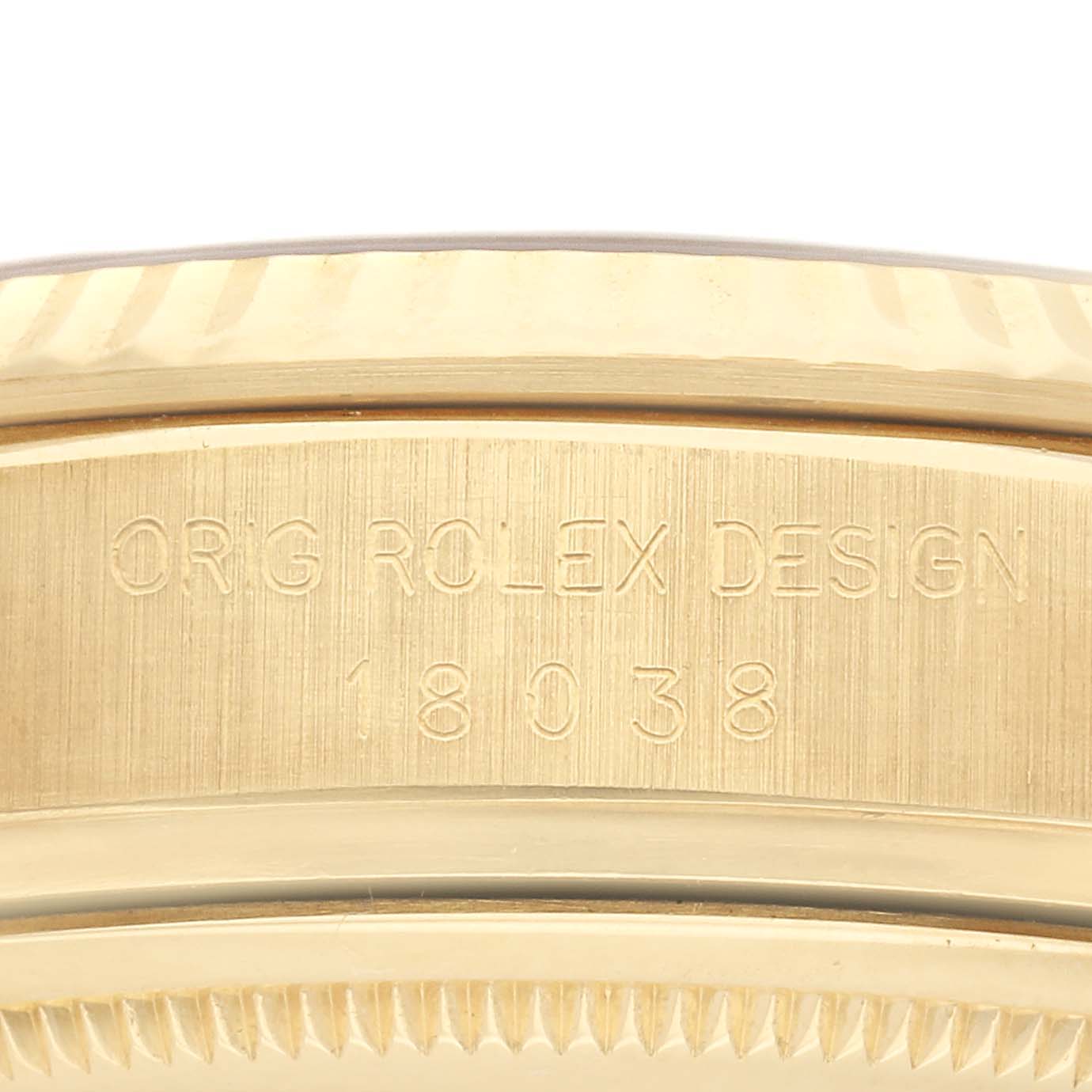 This is a close-up of a Rolex President 18038 Men
s Yellow Gold White Dial 18038 Men
s Yellow Gold White Dial watch
s side, showing the engraved design and model number.