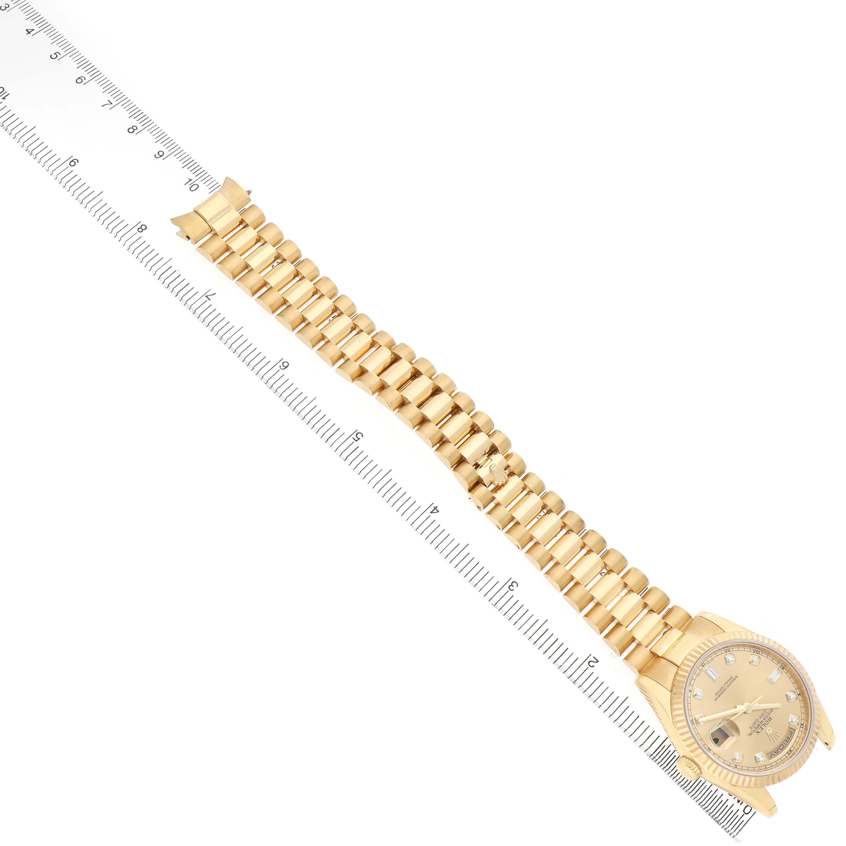 The Rolex President 118238 Men's Yellow Gold Champagne Dial watch is displayed at an angled top view, showing the bracelet, face, and ruler for size reference.