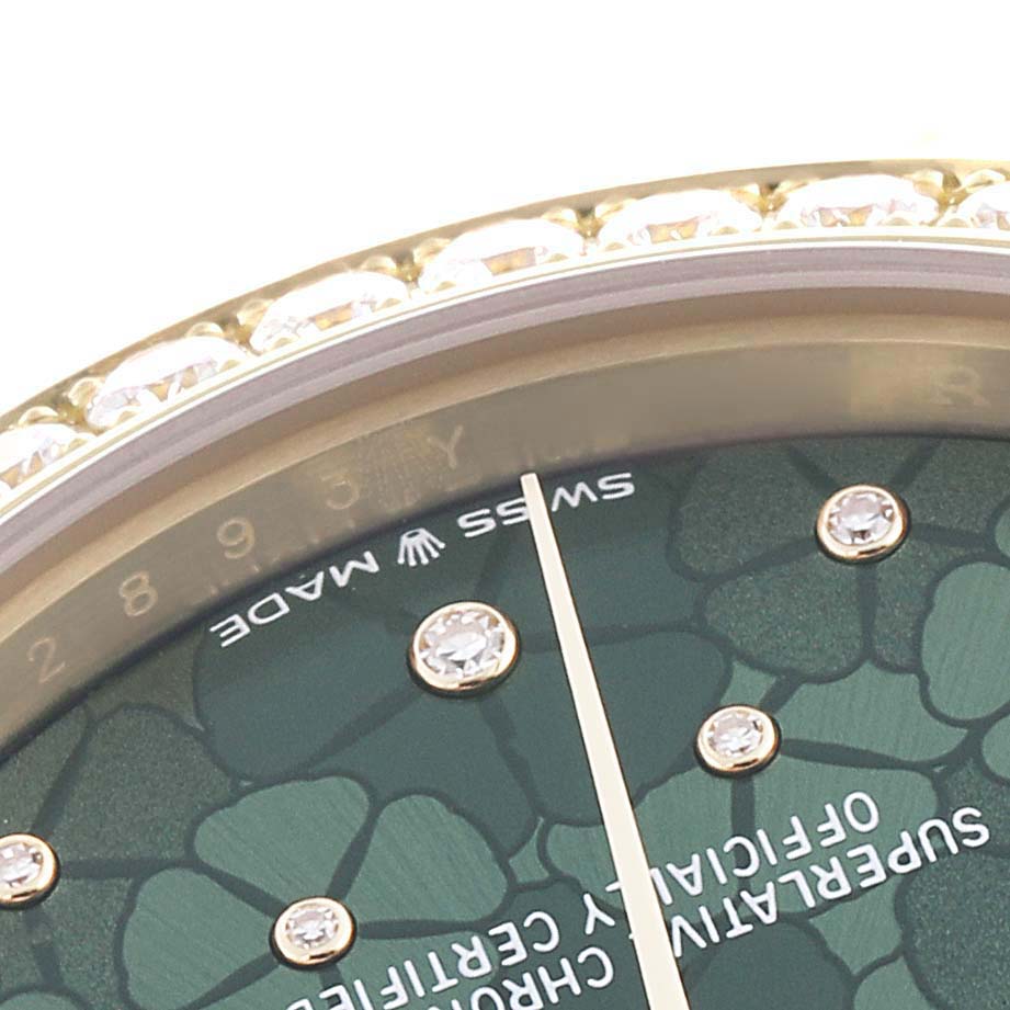 The image shows a close-up of the Rolex Mid-Size watch dial, focusing on the green patterned face and diamond hour markers.