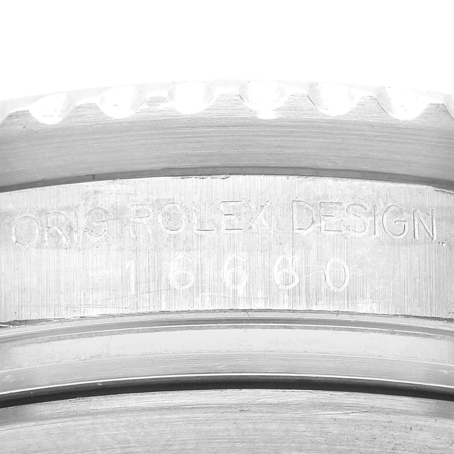 The image shows a close-up of the engraving on the side of the bezel of a Rolex Sea-Dweller 16660 Men
s Stainless Steel Black Dial 16660 Men
s Stainless Steel Black Dial watch.