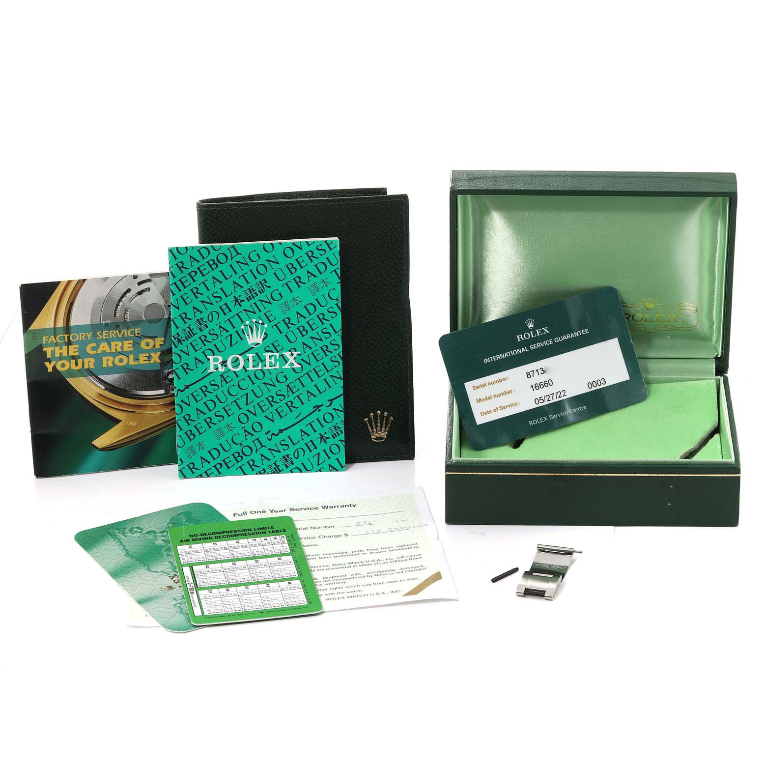 This image shows a top-down view of the box, warranty card, booklet, and extra link for the Rolex Sea-Dweller 16660 Men
s Stainless Steel Black Dial 16660 Men
s Stainless Steel Black Dial watch.