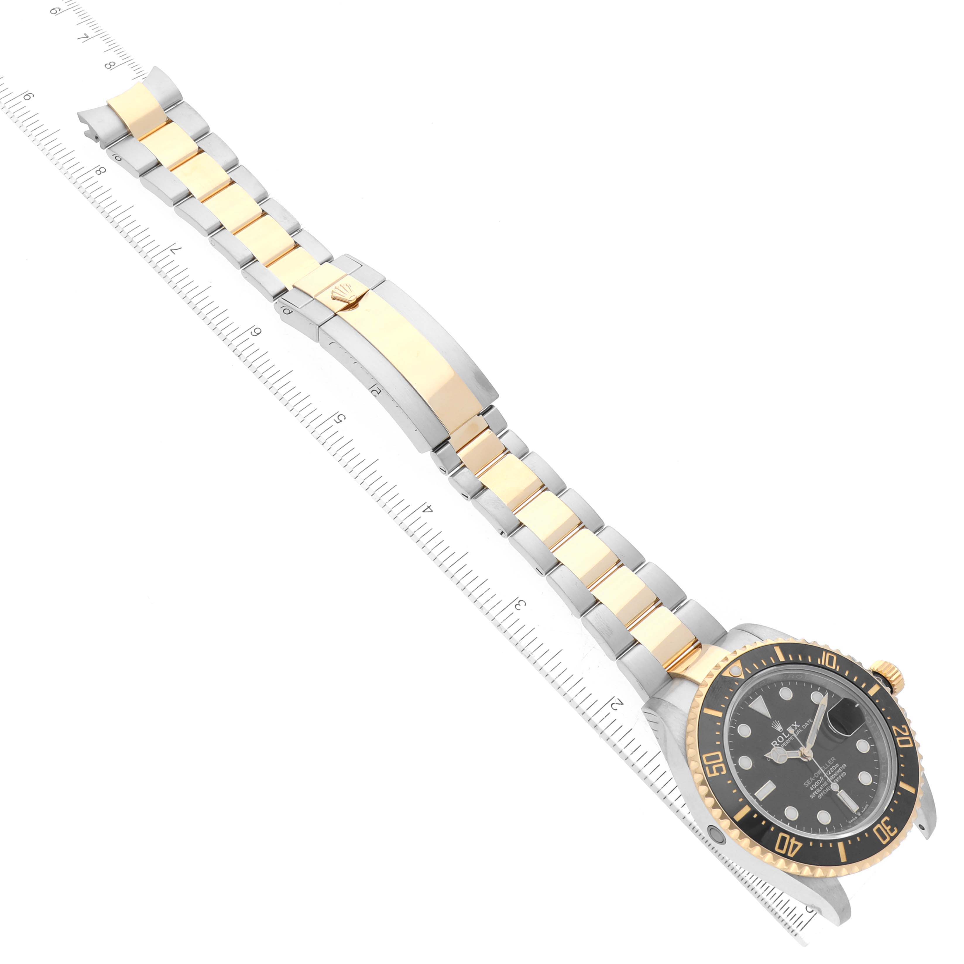 The image shows a Rolex Sea-Dweller 126603 Men's Steel and Gold (two tone) Black Dial 126603 Men's Steel and Gold (two tone) Black Dial watch in gold and silver, including the face, bezel, and entire bracelet, placed beside a ruler.