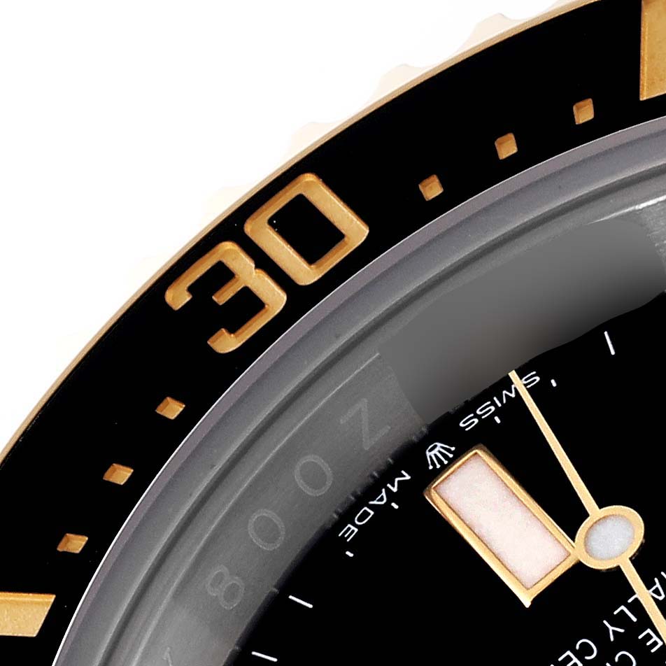 This is a close-up of the bezel, part of the dial, and the minute hand of the Rolex Sea-Dweller 126603 Men's Steel and Gold (two tone) Black Dial 126603 Men's Steel and Gold (two tone) Black Dial watch.