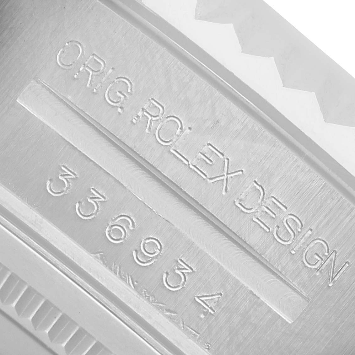 The image shows the engraved side of the Rolex Sky-Dweller 336934 Men's Stainless Steel Green Dial's case with design and serial numbers.