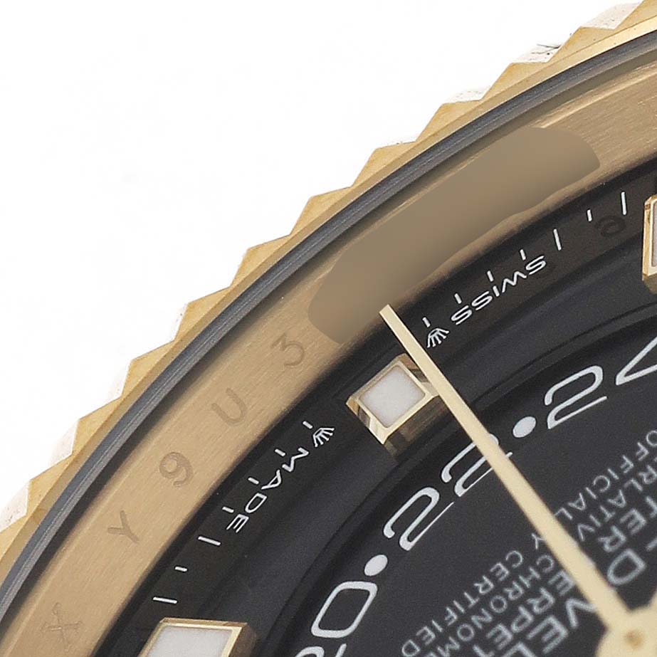 This image shows a close-up of the bezel and part of the dial on a Rolex Sky-Dweller 336238 Men's Yellow Gold Black Dial.