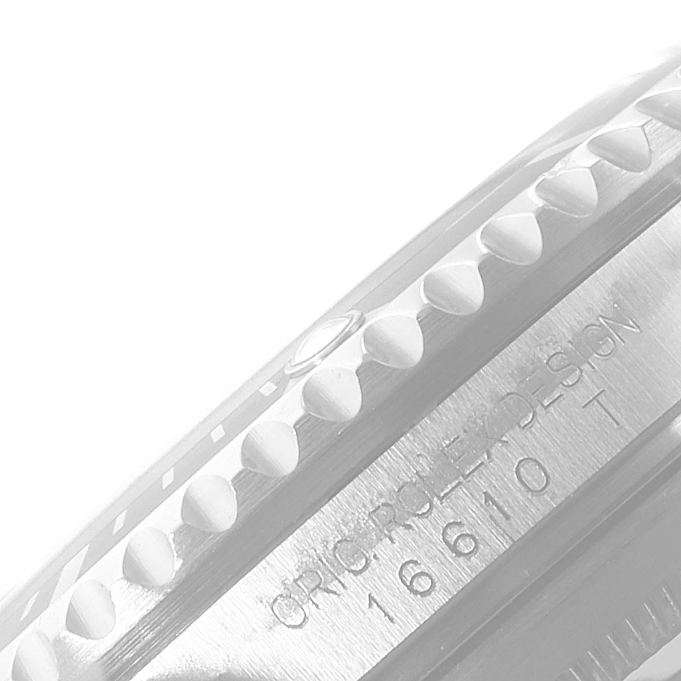 The image shows a close-up of the bezel and partially engraved case of a Rolex Submariner 16610 Men's Stainless Steel Black Dial 16610 Men's Stainless Steel Black Dial watch.