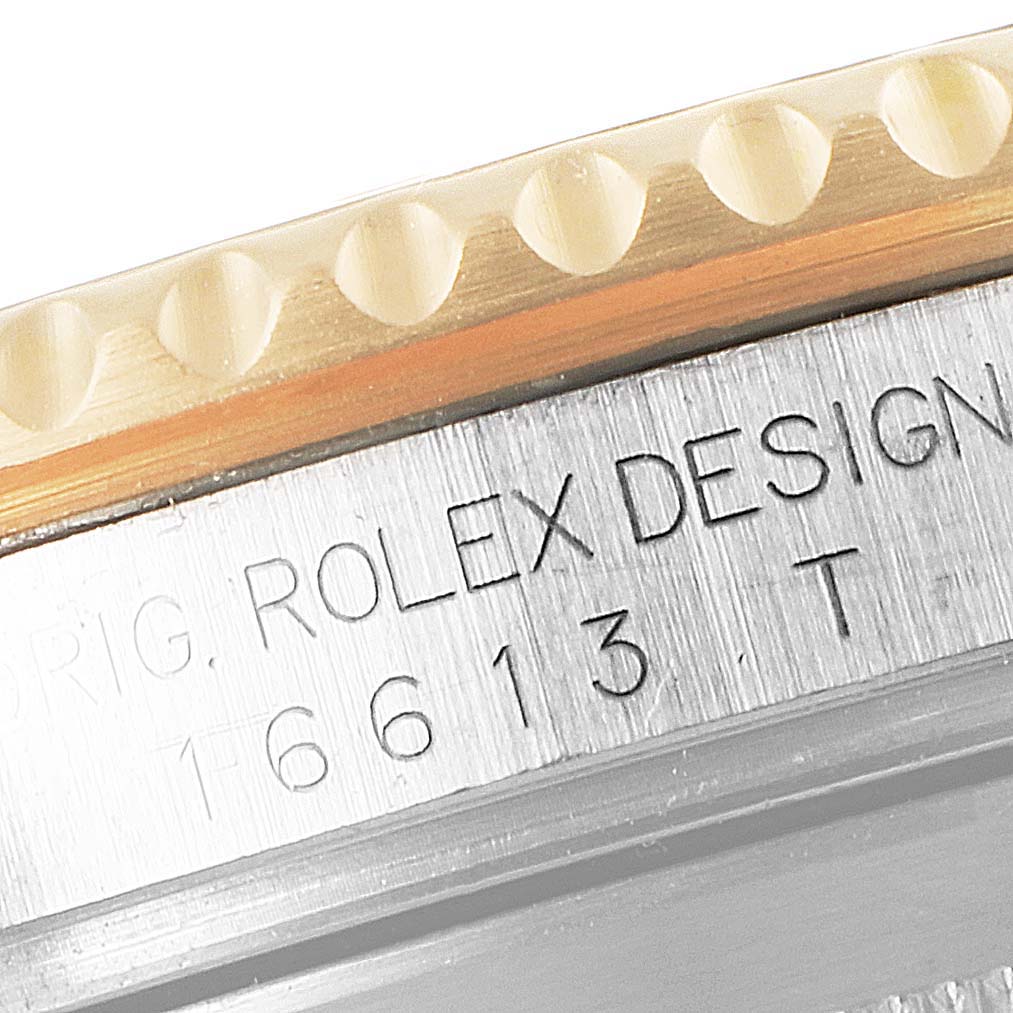 Close-up of the bezel edge and engraved case of a Rolex Submariner 16613 Men
s Steel and Gold (two tone) Blue Dial 16613 Men
s Steel and Gold (two tone) Blue Dial, highlighting model number 16613T.
