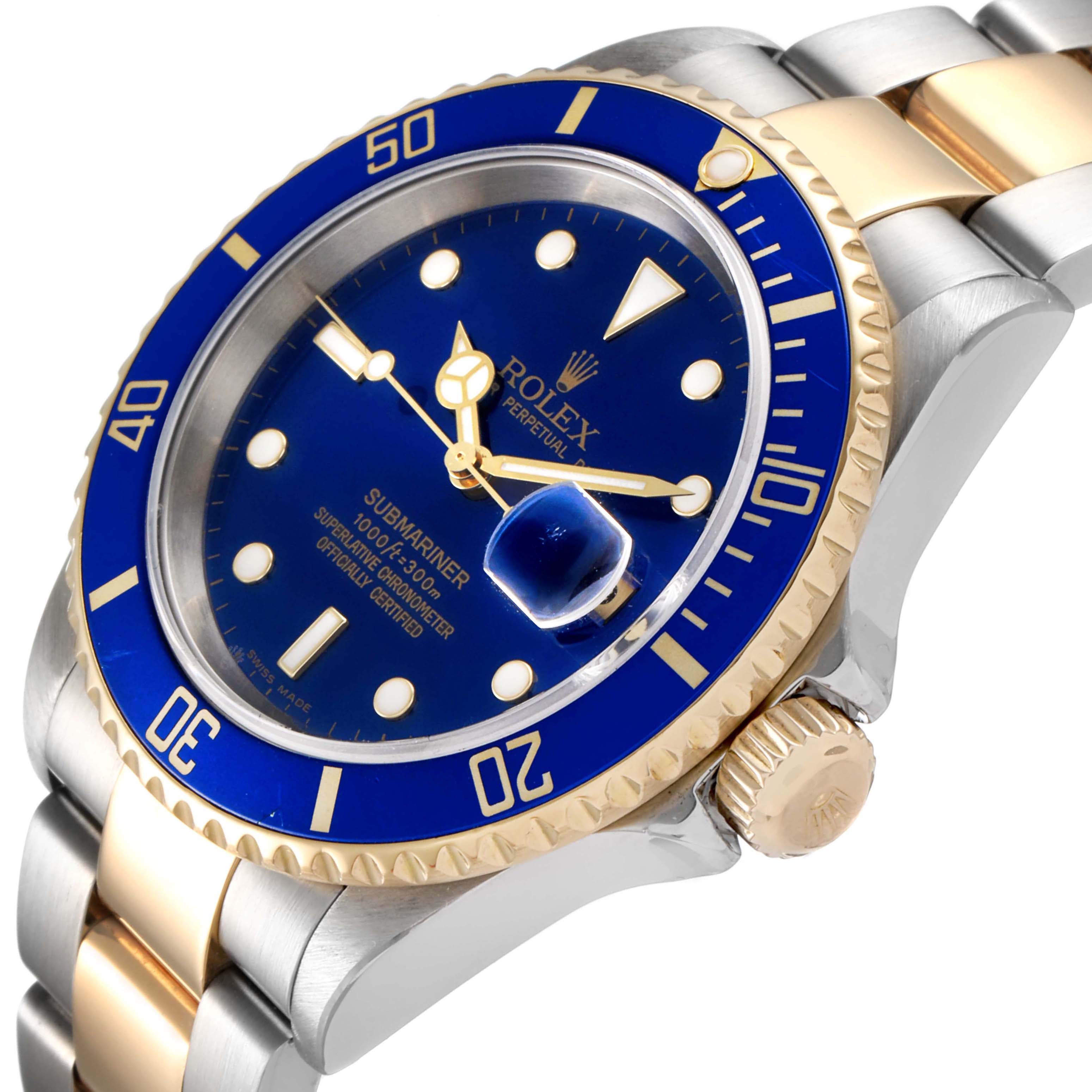 The image shows a Rolex Submariner 16613 Men
s Steel and Gold (two tone) Blue Dial 16613 Men
s Steel and Gold (two tone) Blue Dial watch at an angle emphasizing its dial, bezel, and bracelet.