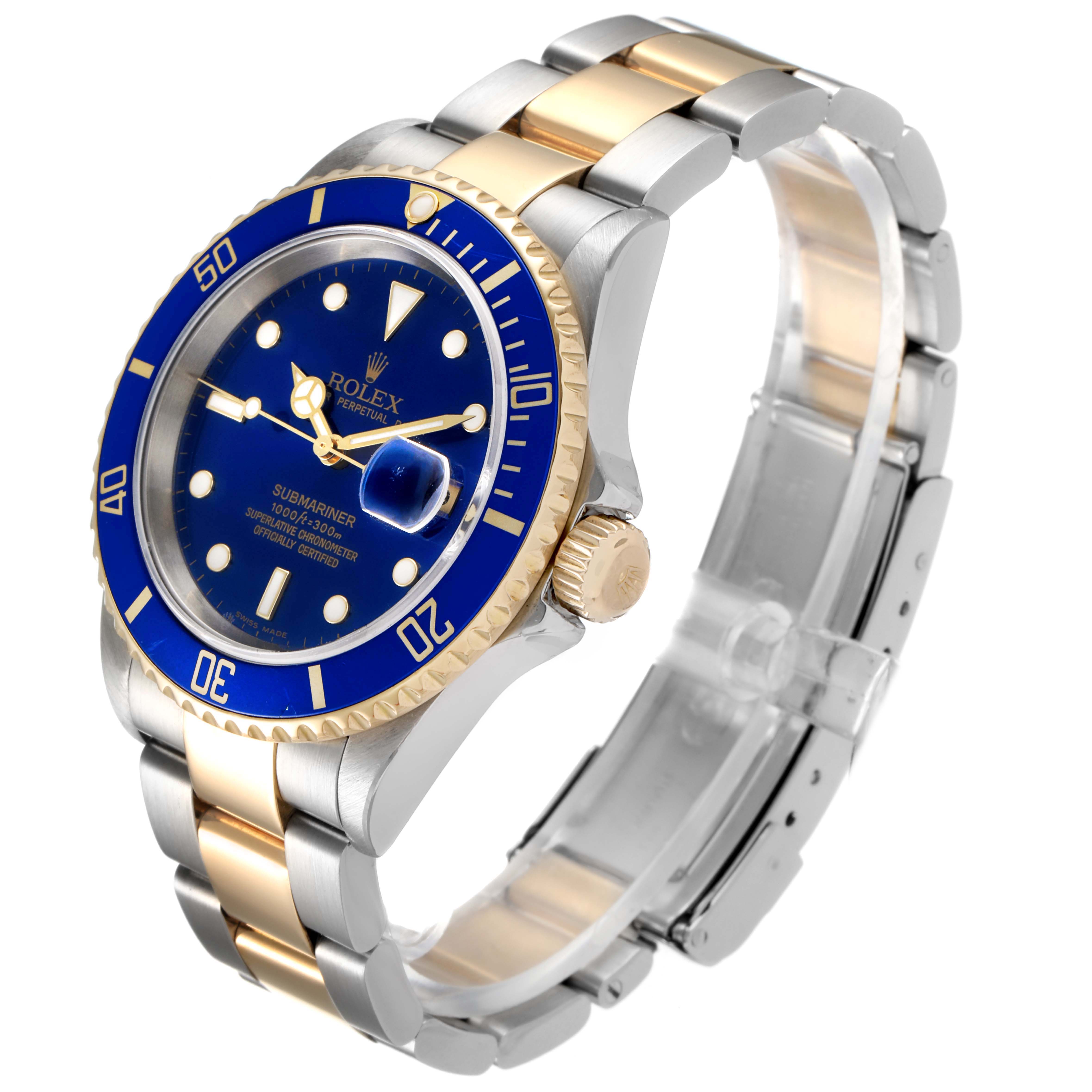 This image shows a Rolex Submariner 16613 Men
s Steel and Gold (two tone) Blue Dial 16613 Men
s Steel and Gold (two tone) Blue Dial watch at a three-quarter angle, highlighting its blue dial, bezel, and two-tone bracelet.
