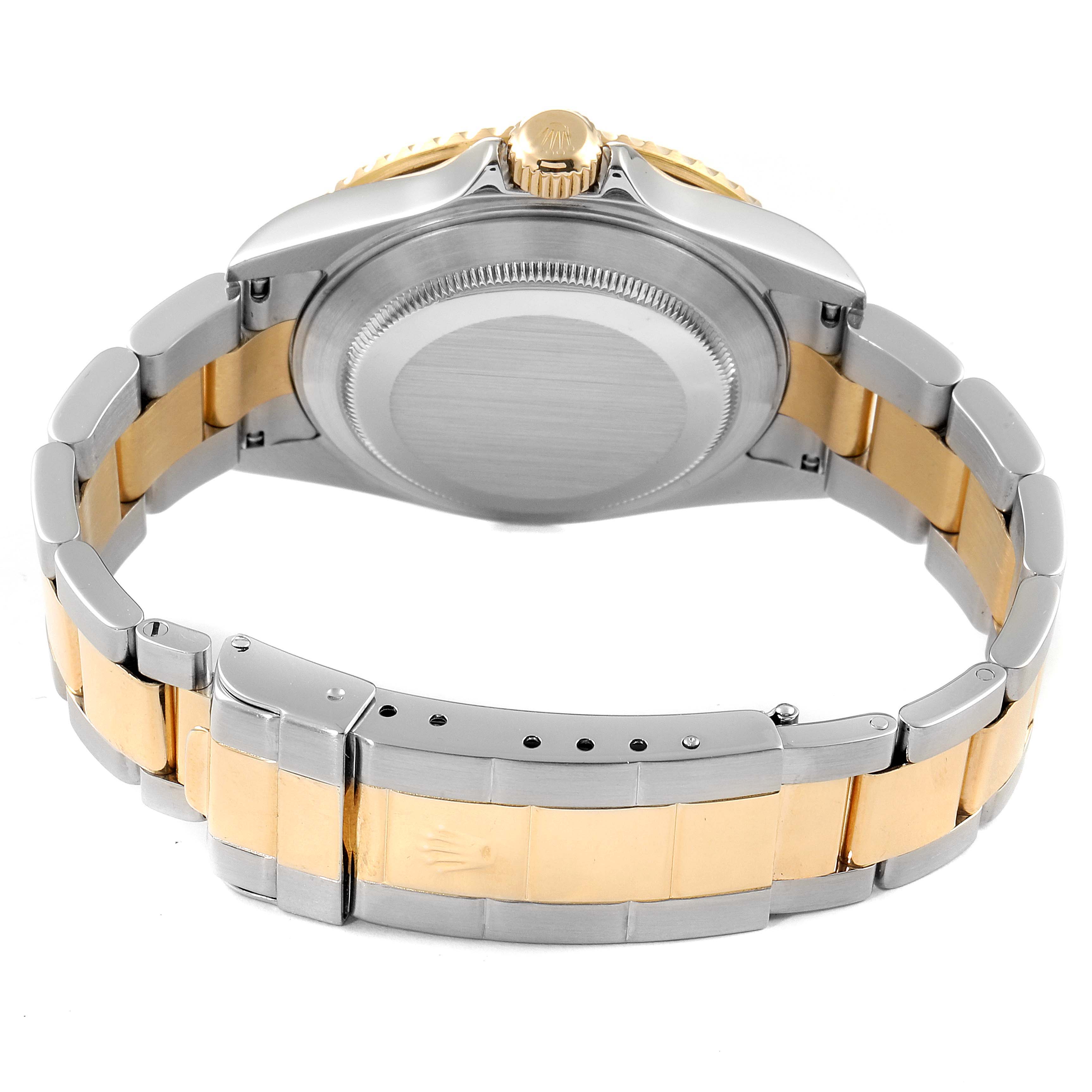 The image shows the back view of a Rolex Submariner 16613 Men
s Steel and Gold (two tone) Blue Dial 16613 Men
s Steel and Gold (two tone) Blue Dial with its bracelet, clasp, and case back visible.