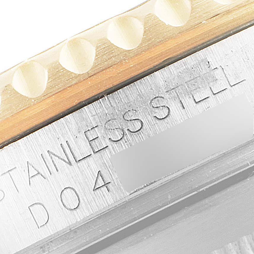 This close-up shows the bezel and the engraved case of a Rolex Submariner 16613 Men
s Steel and Gold (two tone) Blue Dial 16613 Men
s Steel and Gold (two tone) Blue Dial watch, highlighting the "STAINLESS STEEL" marking.