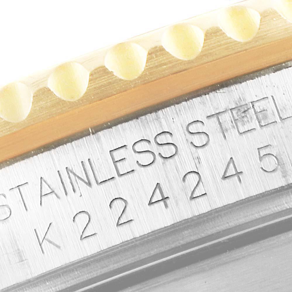 This image shows a close-up of the bezel and engraved stainless steel part of a Rolex Submariner 16613 Men
s Steel and Gold (two tone) Blue Dial 16613 Men
s Steel and Gold (two tone) Blue Dial watch.