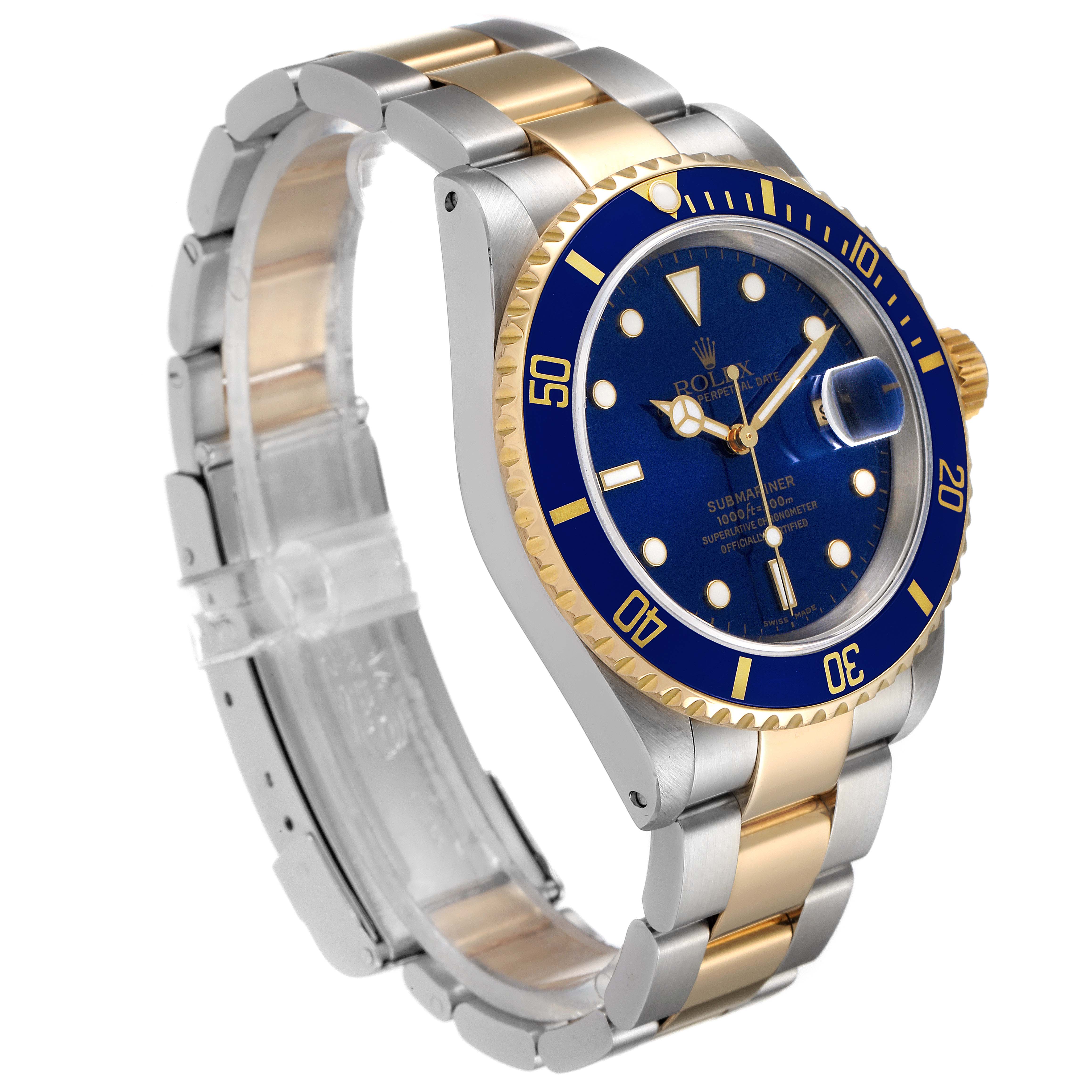 The image shows an angled view of a Rolex Submariner 16613 Men
s Steel and Gold (two tone) Blue Dial 16613 Men
s Steel and Gold (two tone) Blue Dial watch emphasizing the blue dial, bezel, and two-tone bracelet.