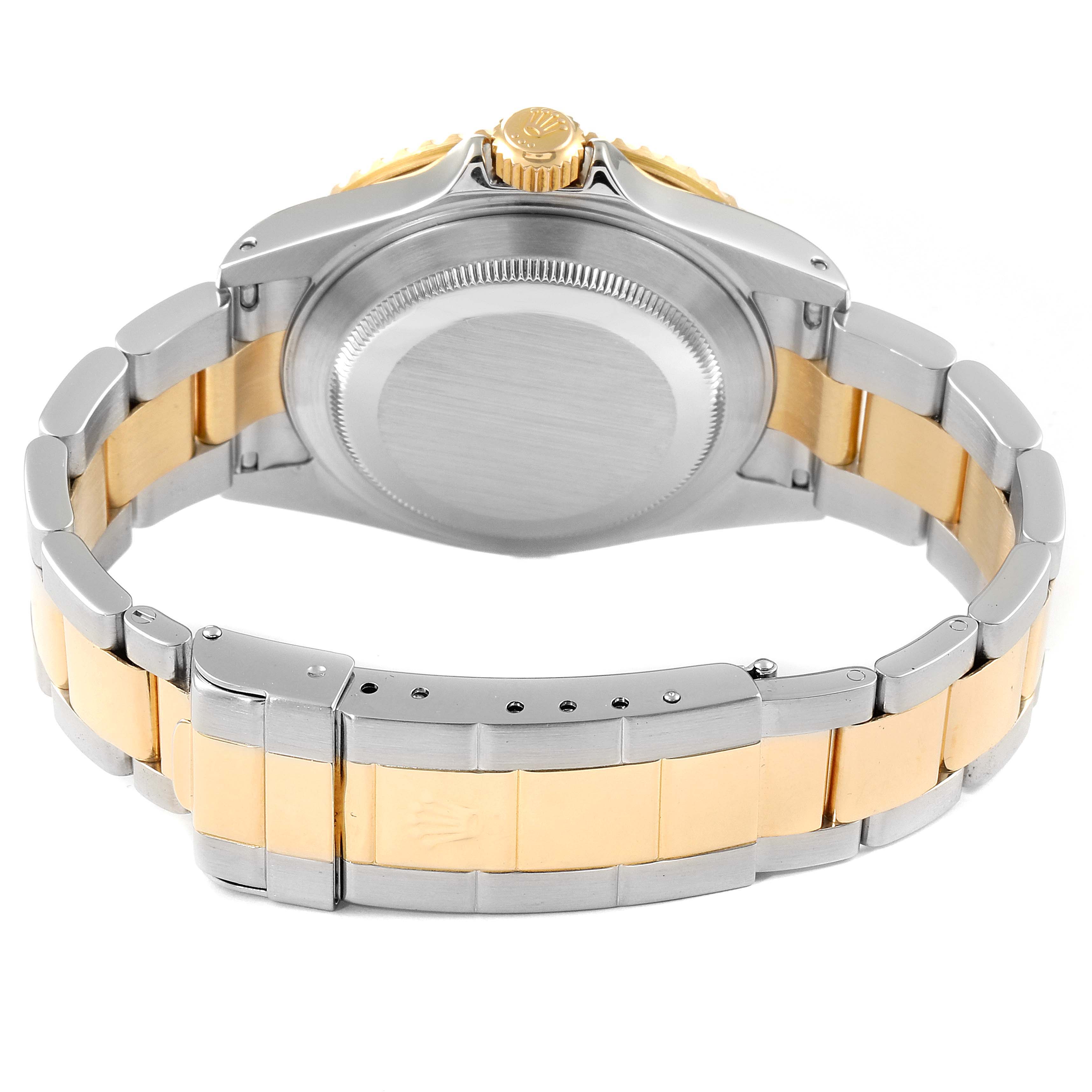 The image shows the back view of a Rolex Submariner 16613 Men
s Steel and Gold (two tone) Blue Dial 16613 Men
s Steel and Gold (two tone) Blue Dial watch, highlighting the case back and a two-tone metal bracelet.