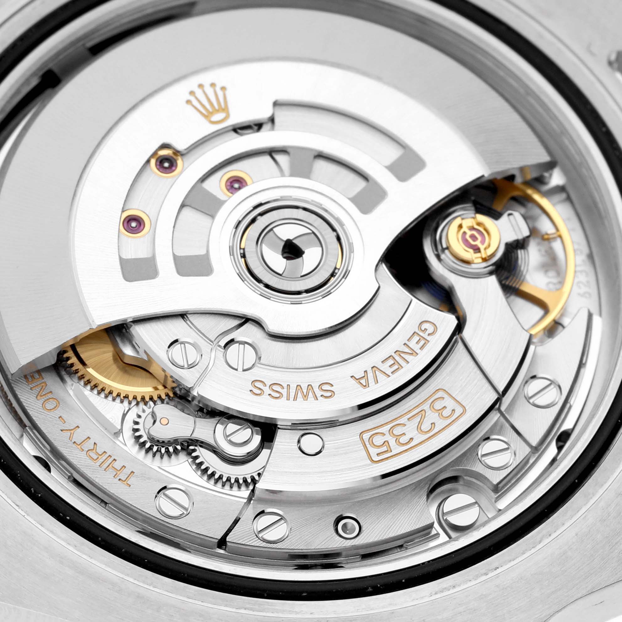 The image shows a close-up of the movement mechanism inside a Rolex Submariner 126610LV Men
s Stainless Steel Black Dial 126610LV Men
s Stainless Steel Black Dial watch, showcasing its intricate components and engravings.
