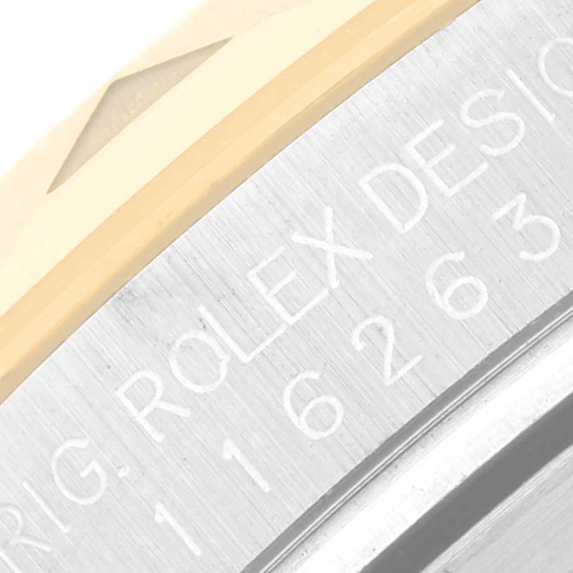 The image shows a close-up angle of the bezel and part of the casing of the Rolex Turn-o-Graph 116263 Men
s Steel and Gold (two tone) White Dial 116263 Men
s Steel and Gold (two tone) White Dial model, featuring engraved text and markings.