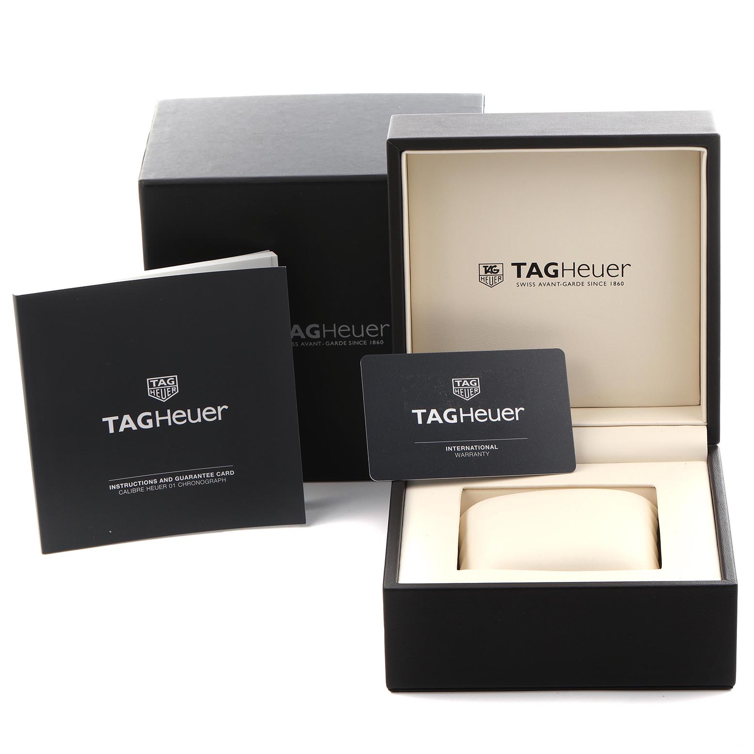 The image shows the Tag Heuer Carrera CAR2A1Z Men
s Stainless Steel Black Dial CAR2A1Z Men
s Stainless Steel Black Dial box, warranty card, and instruction booklet from a frontal angle.