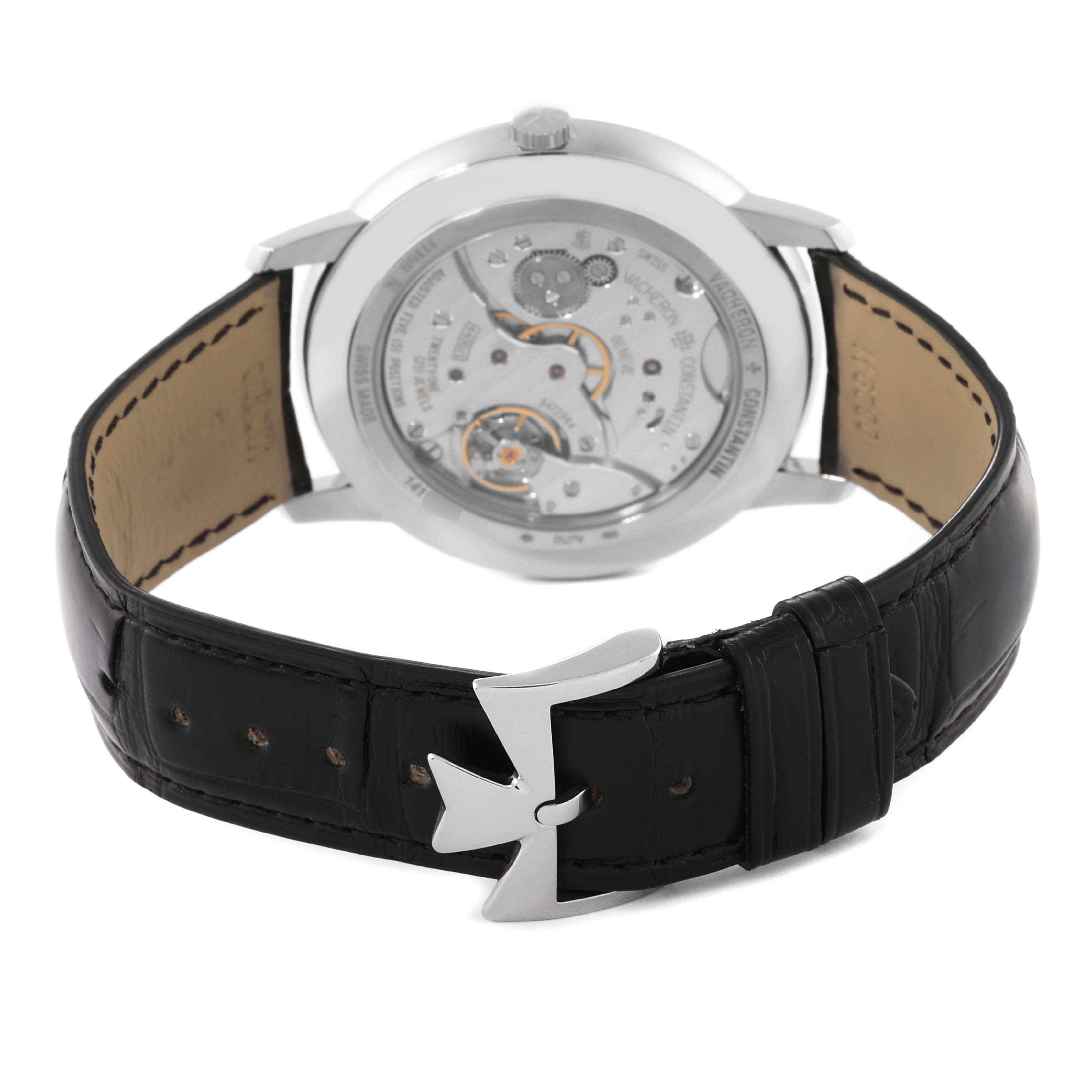 The image shows the back view of a Vacheron Constantin Patrimony 1110U/000G-B086 Men's White Gold Silver Dial 1110U/000G-B086 Men's White Gold Silver Dial watch, highlighting the movement and black leather strap with a logo-shaped clasp.