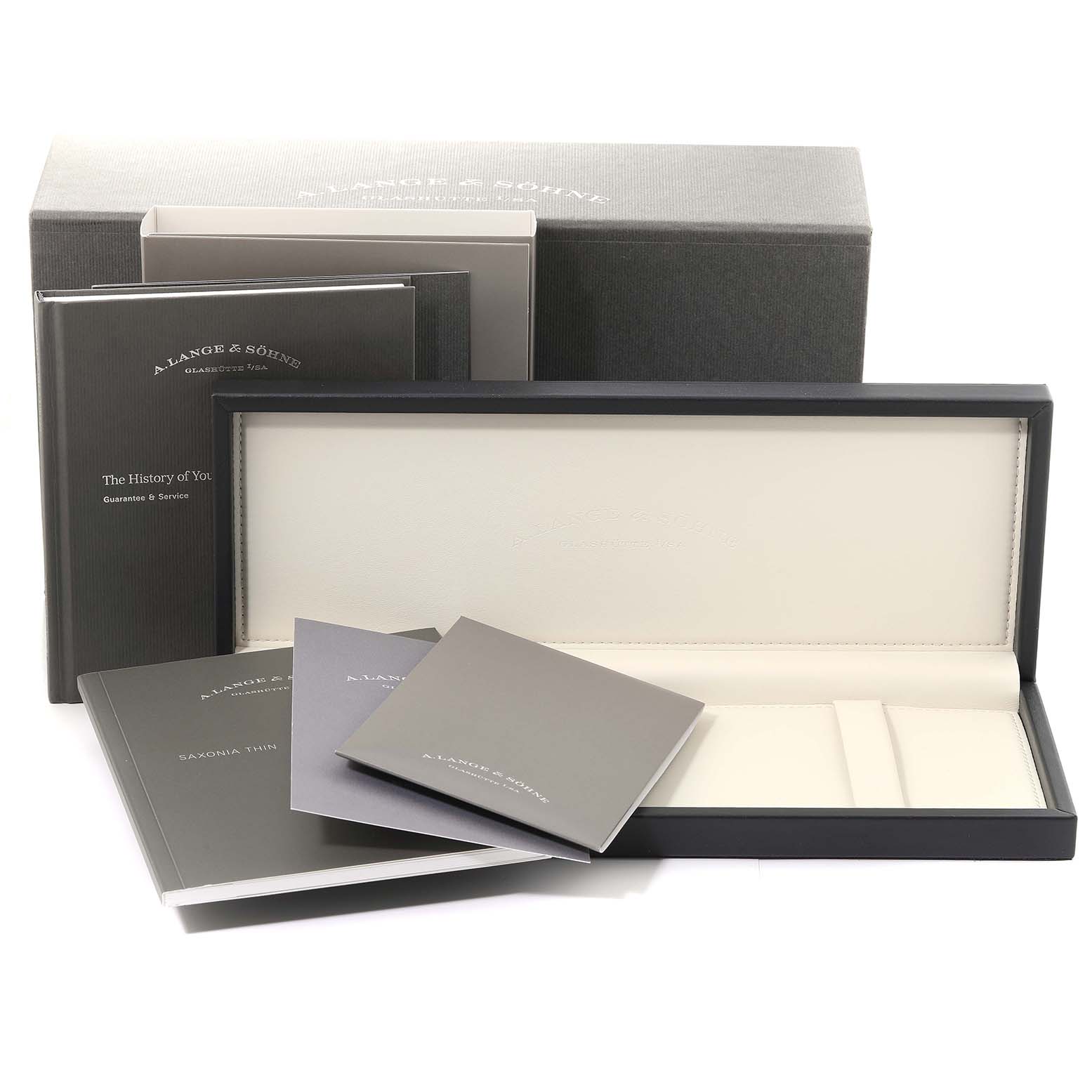 This is a packaging set for the Saxonia model by A. Lange 
Söhne, showing the box, manuals, and inner display case.