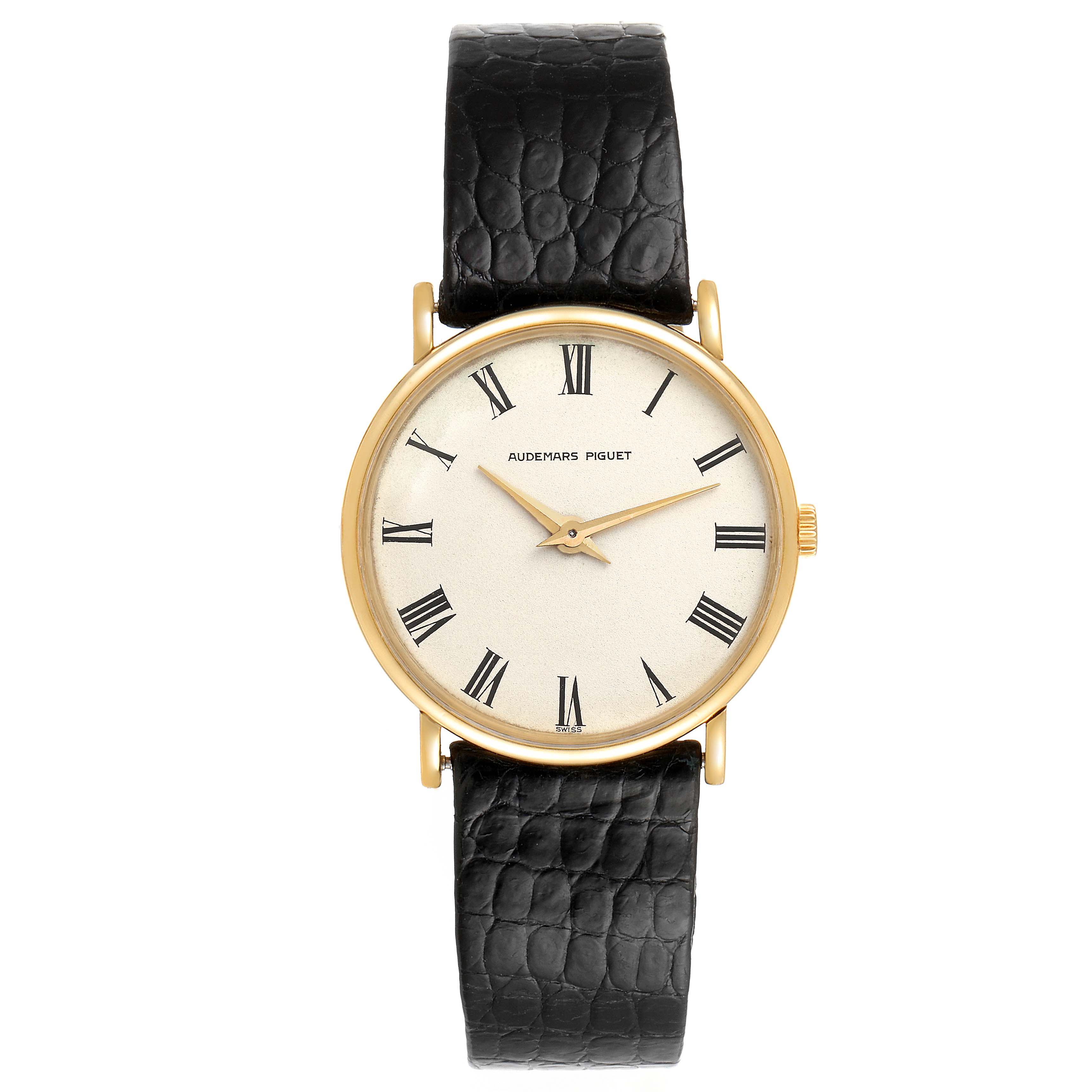 This image shows a vintage Audemars Piguet watch with a gold case, white dial, black Roman numerals, and a black leather strap.