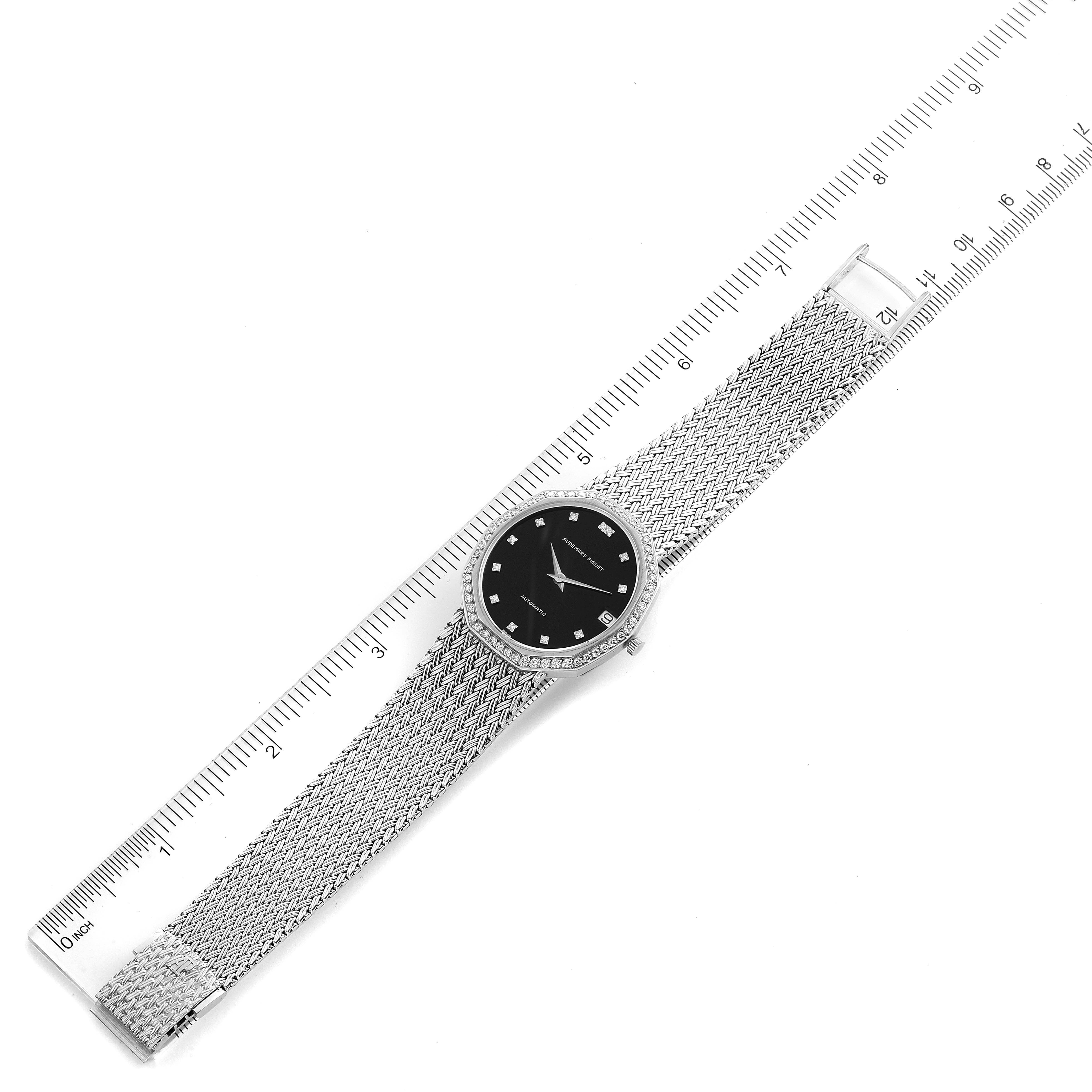 The image shows a Vintage model by Audemars Piguet laid flat with a ruler, displaying its dial, mesh bracelet, and crown from a top-down angle.