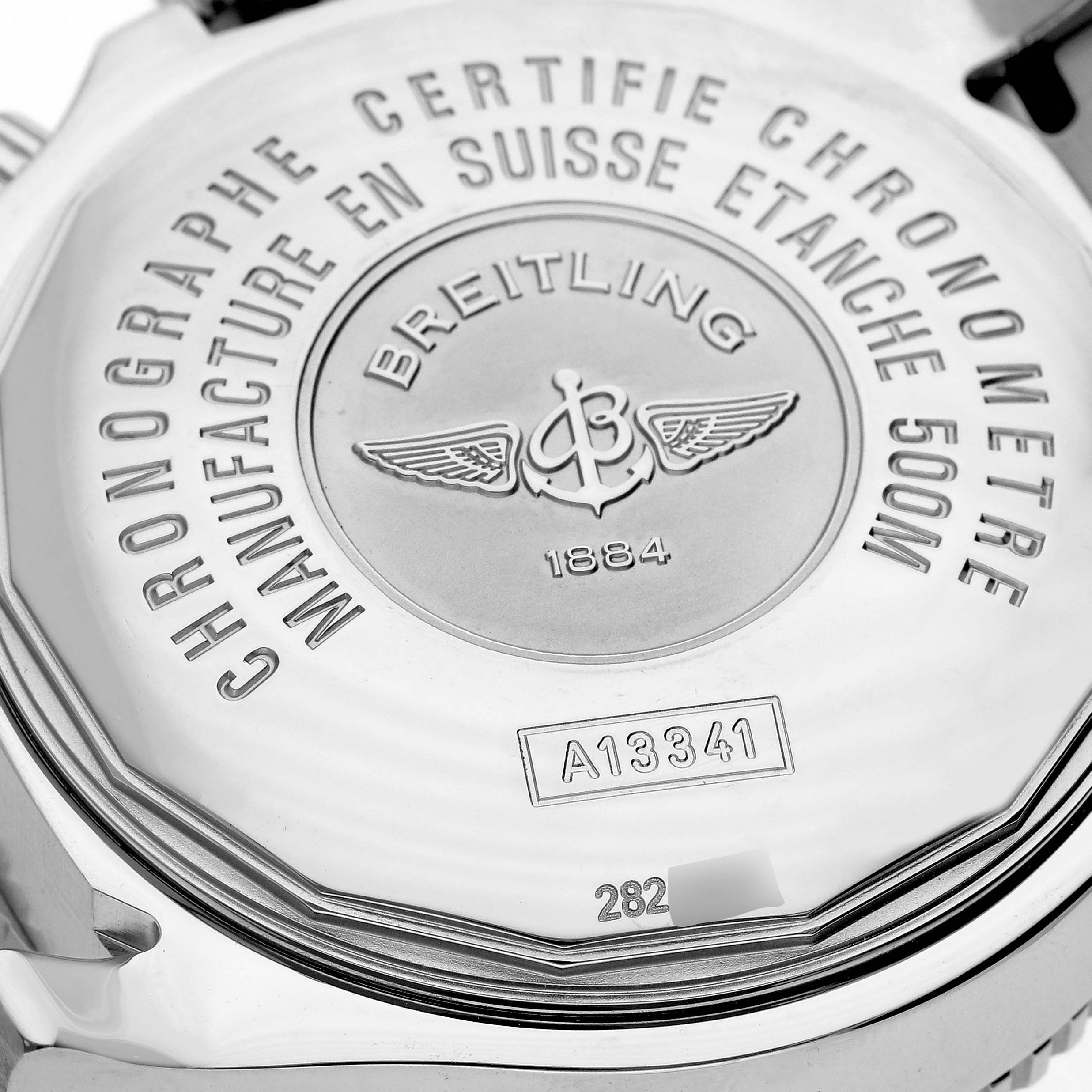 The image shows the back case of a Breitling Superocean A13341 Men's Stainless Steel Black Dial A13341 Men's Stainless Steel Black Dial watch, highlighting its engravings and serial number.