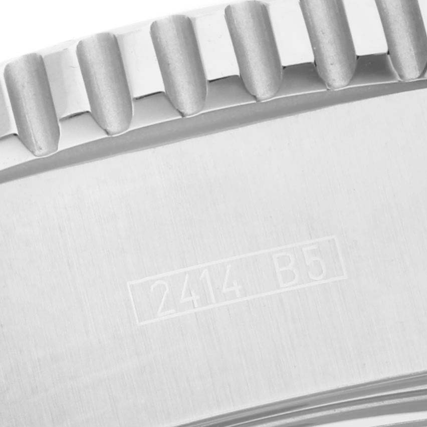 The image shows the close-up of the bezel and some stamped markings on the Superocean model by Breitling.