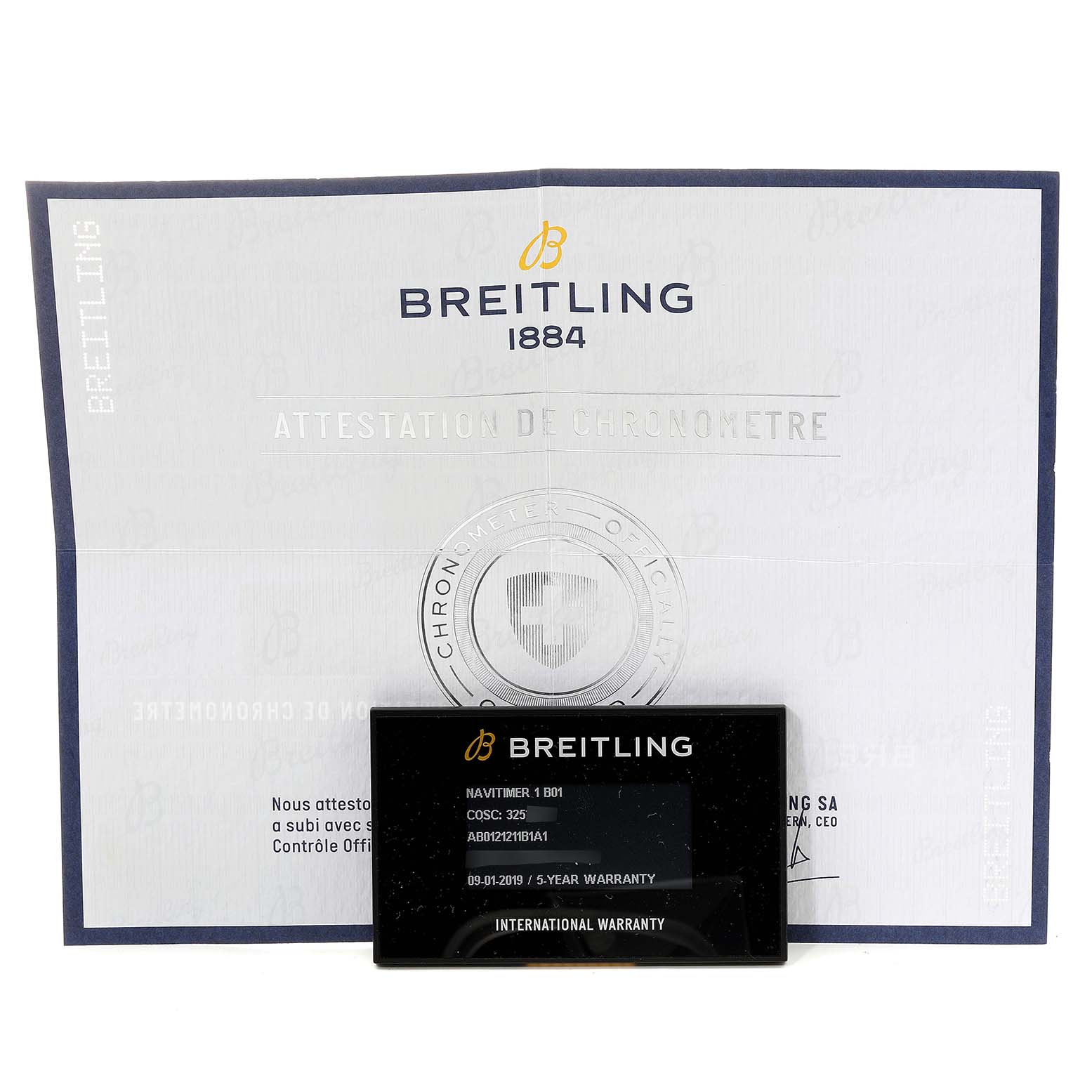 The image shows the warranty card and certification documents for the Navitimer 1 B01 model by Breitling.