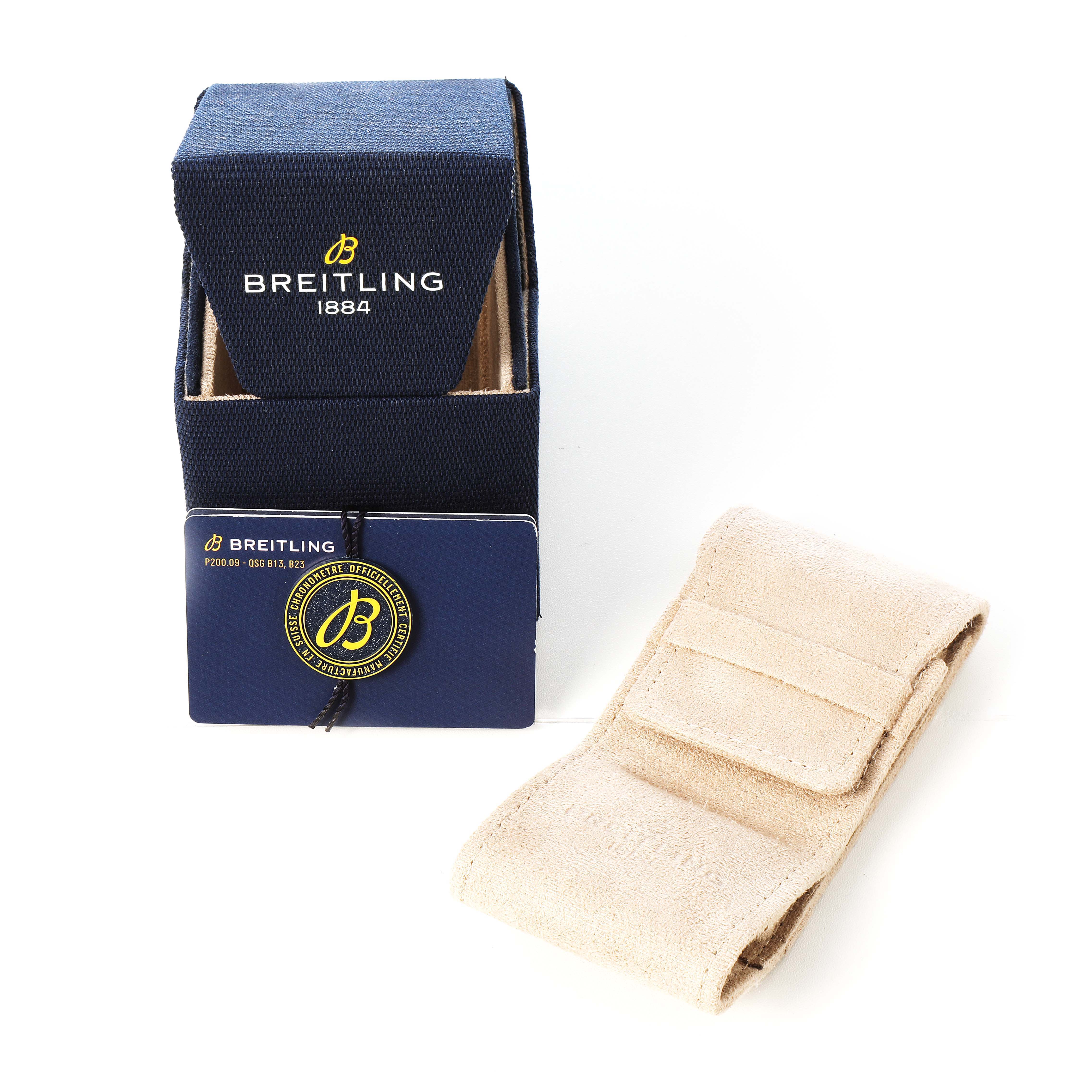 The image shows a Breitling Navitimer AB0121 Men's Stainless Steel Black Dial watch box, warranty card, and a beige suede pouch.