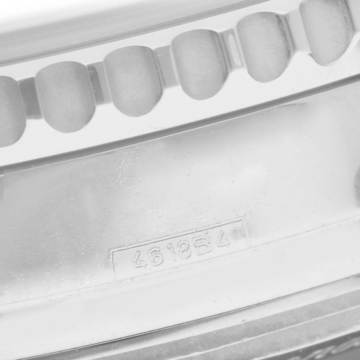 The image shows a close-up of the edge and engravings on the bezel of a Breitling Navitimer AB0121 Men's Stainless Steel Black Dial watch.