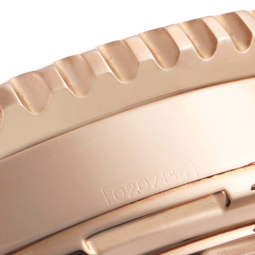 The image shows a close-up of the bezel and part of the case of a Breitling Navitimer R23322 Men's Rose Gold Black Dial R23322 Men's Rose Gold Black Dial watch.