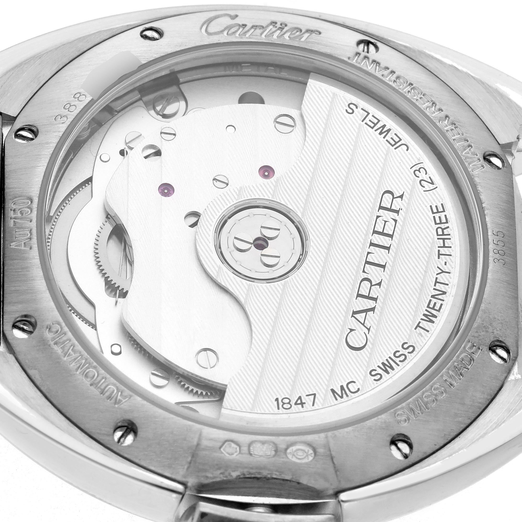 The image shows the back view of the Cartier Clé watch, highlighting its mechanical movement and inscription details.