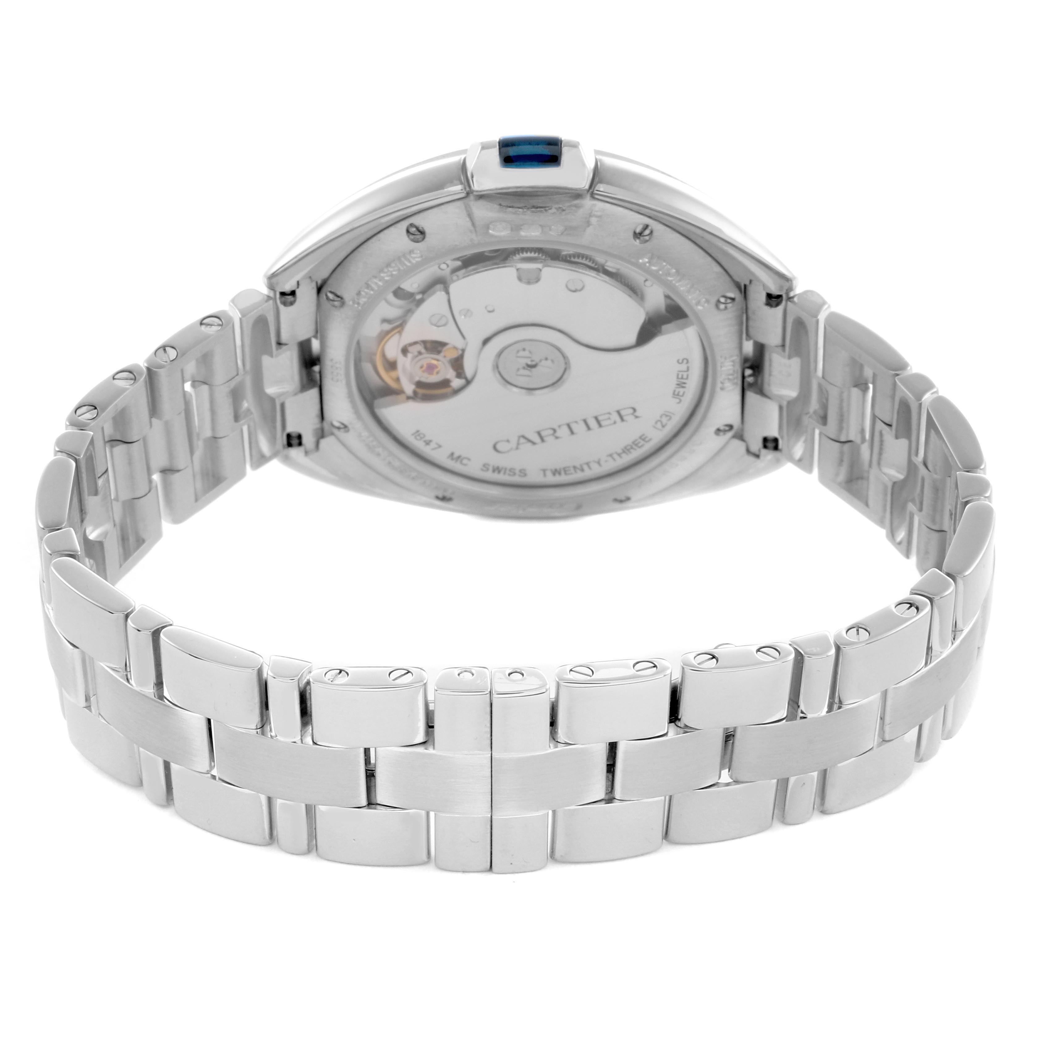 The Cartier Clé watch is shown from the back, highlighting its transparent case back and metal bracelet.