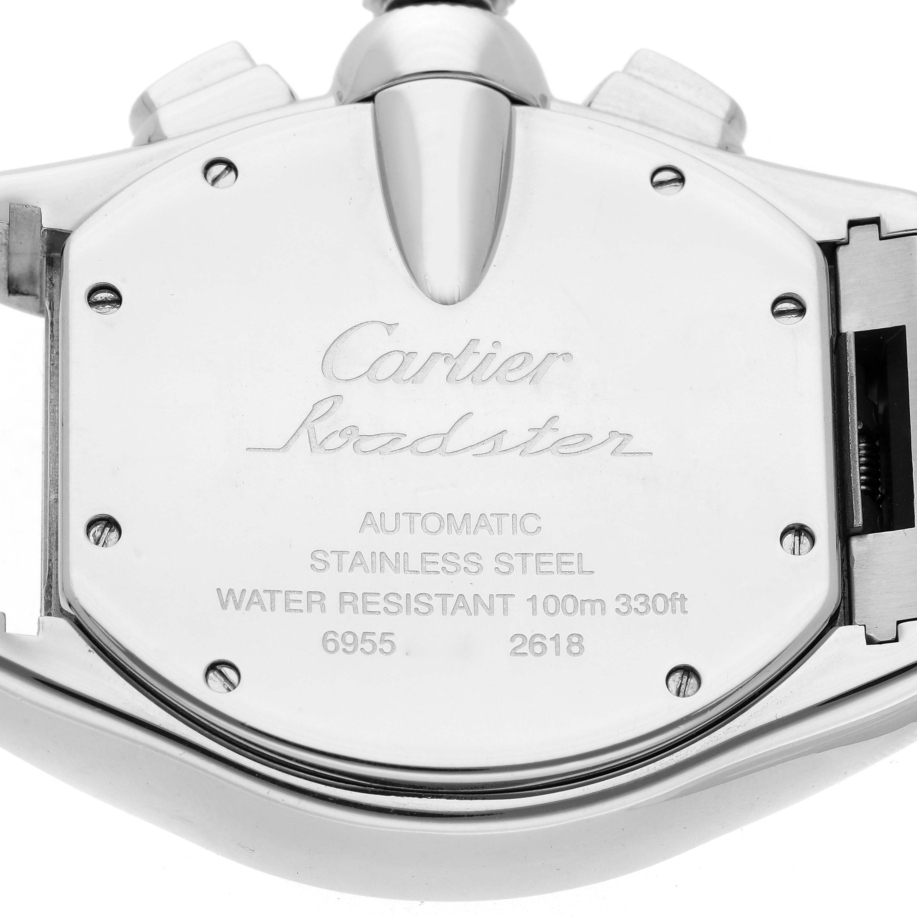 The image shows the back casing of a Cartier Roadster W62020X6 Men
s Stainless Steel Black Dial W62020X6 Men
s Stainless Steel Black Dial watch, displaying engraved details and screws.