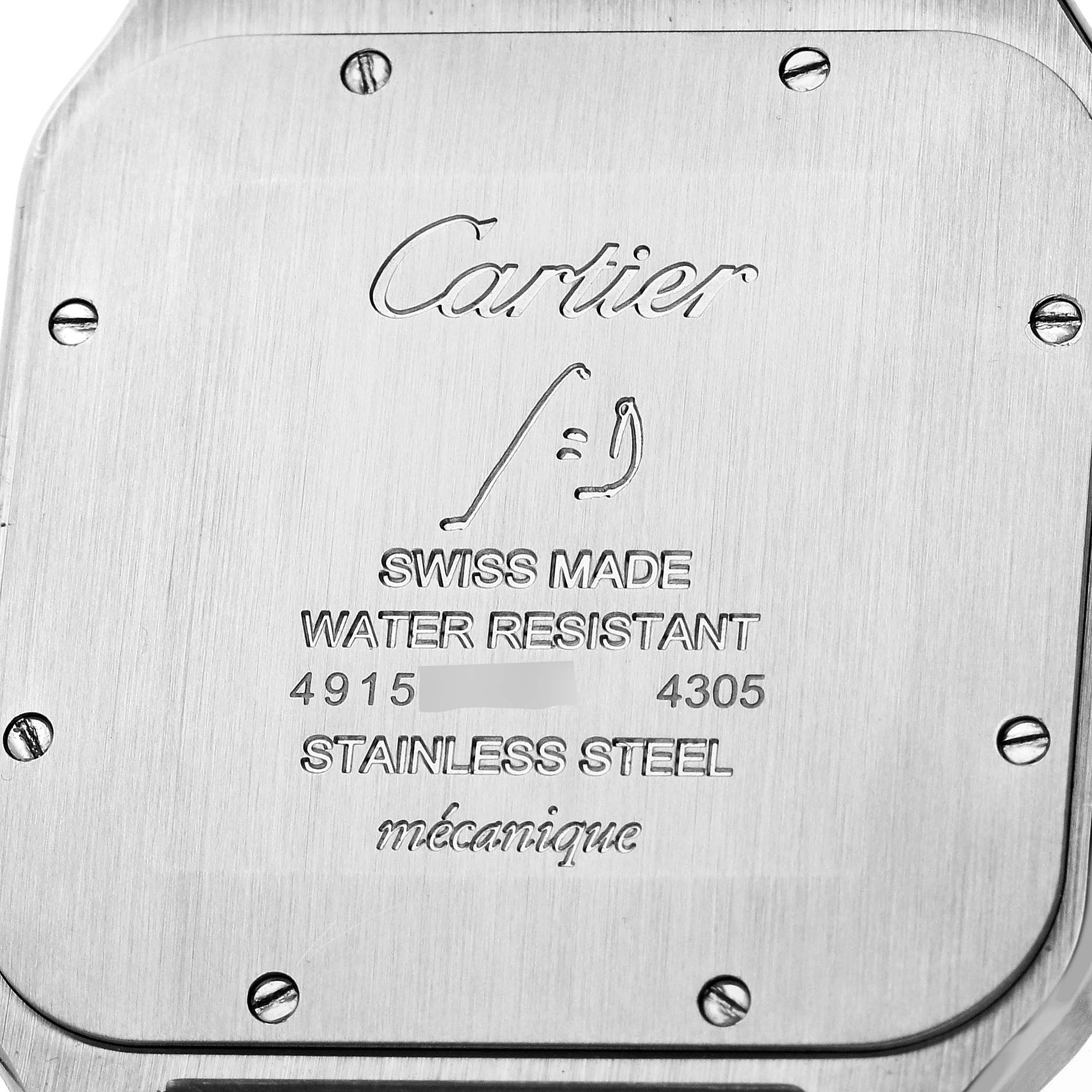 This image shows the back case of a Santos Dumont watch by Cartier, featuring engraved details and screws.