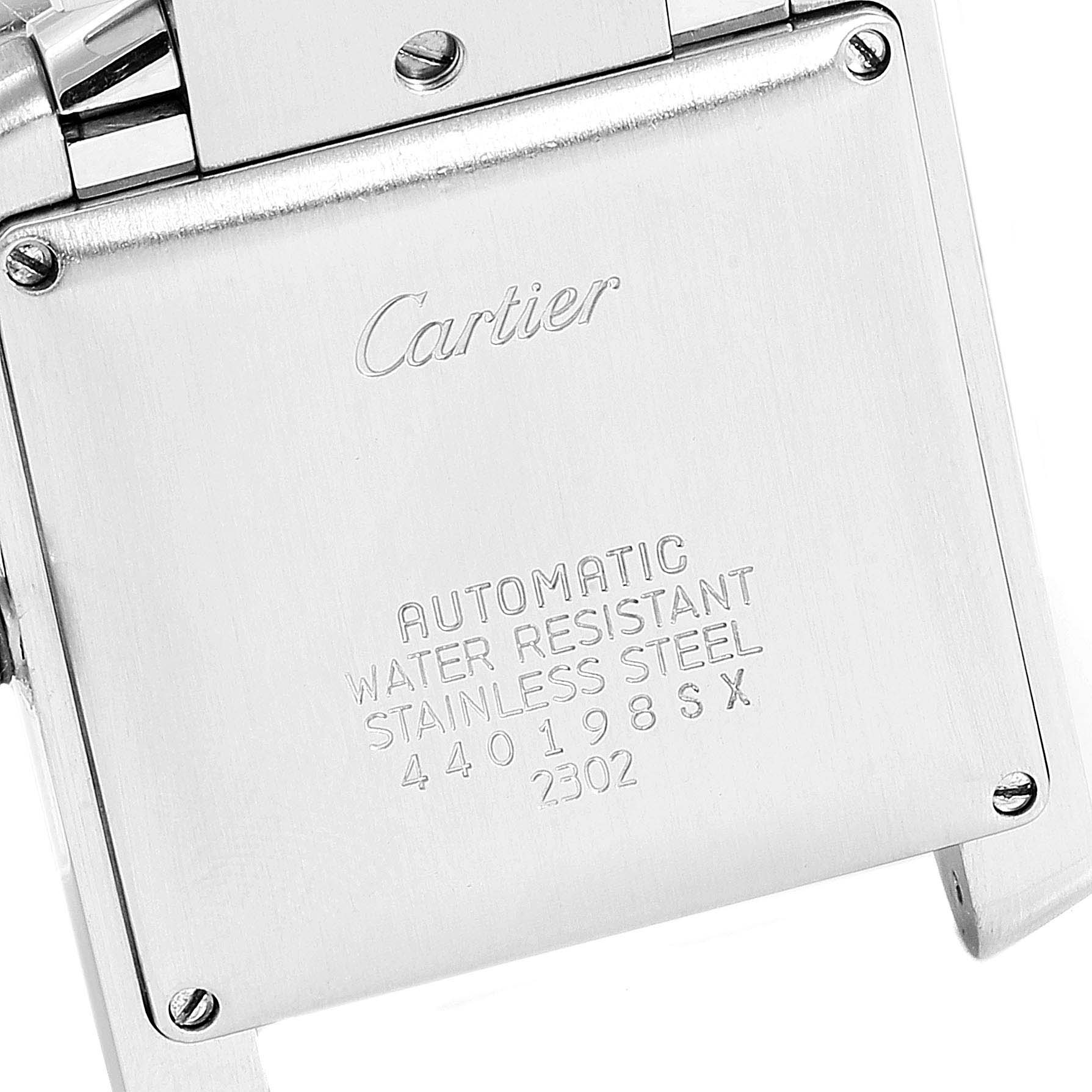 The image shows the back casing of a Cartier Tank Française watch, highlighting the brand name and material details.