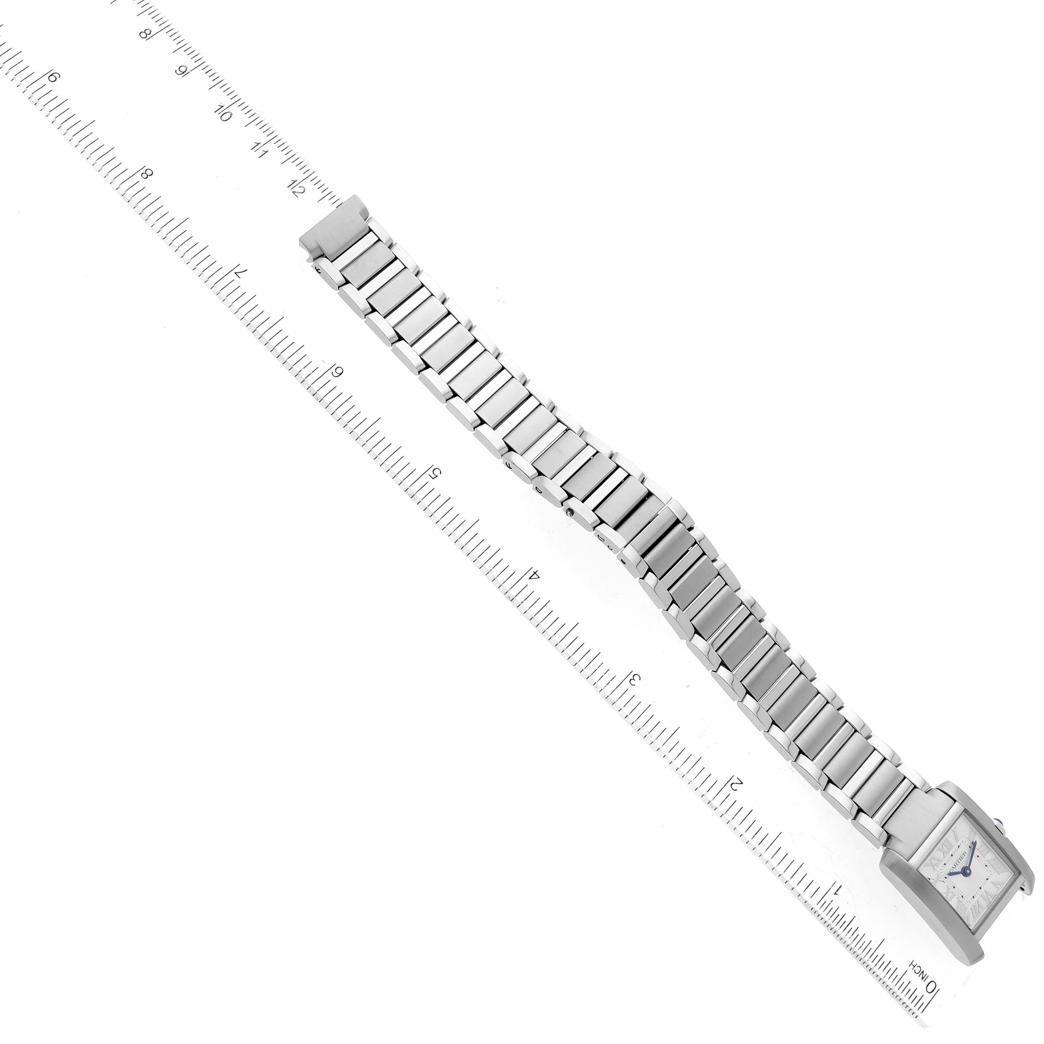 The Cartier Tank Francaise WSTA0065 Women
s Stainless Steel Silver Dial WSTA0065 Women
s Stainless Steel Silver Dial watch is shown in a top view with its face and full metal bracelet displayed alongside a ruler for scale.