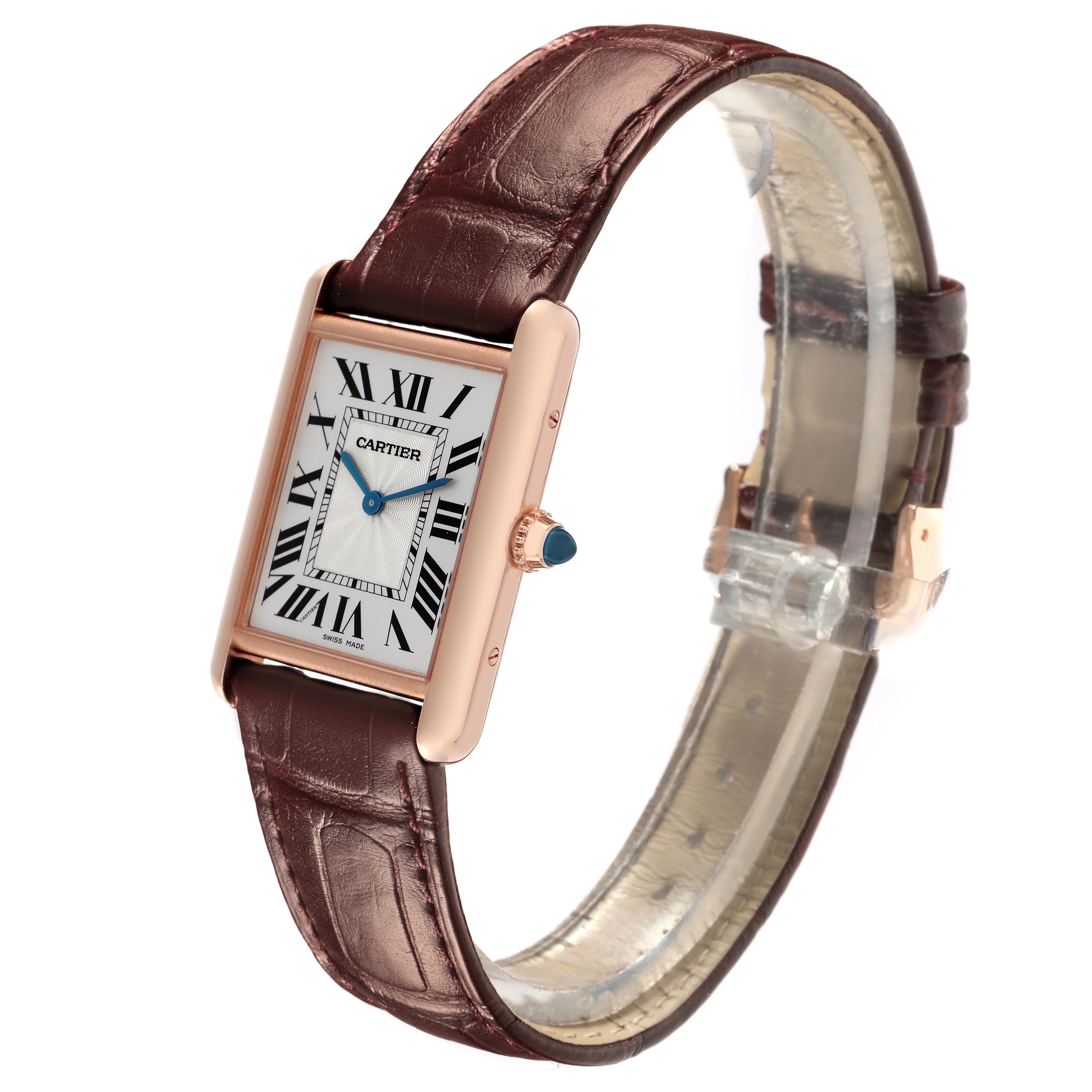 The Cartier Tank Louis WGTA0011 Men
s Rose Gold Silver Dial WGTA0011 Men
s Rose Gold Silver Dial watch is shown at an angle highlighting its rectangular case, brown leather strap, and blue cabochon crown.