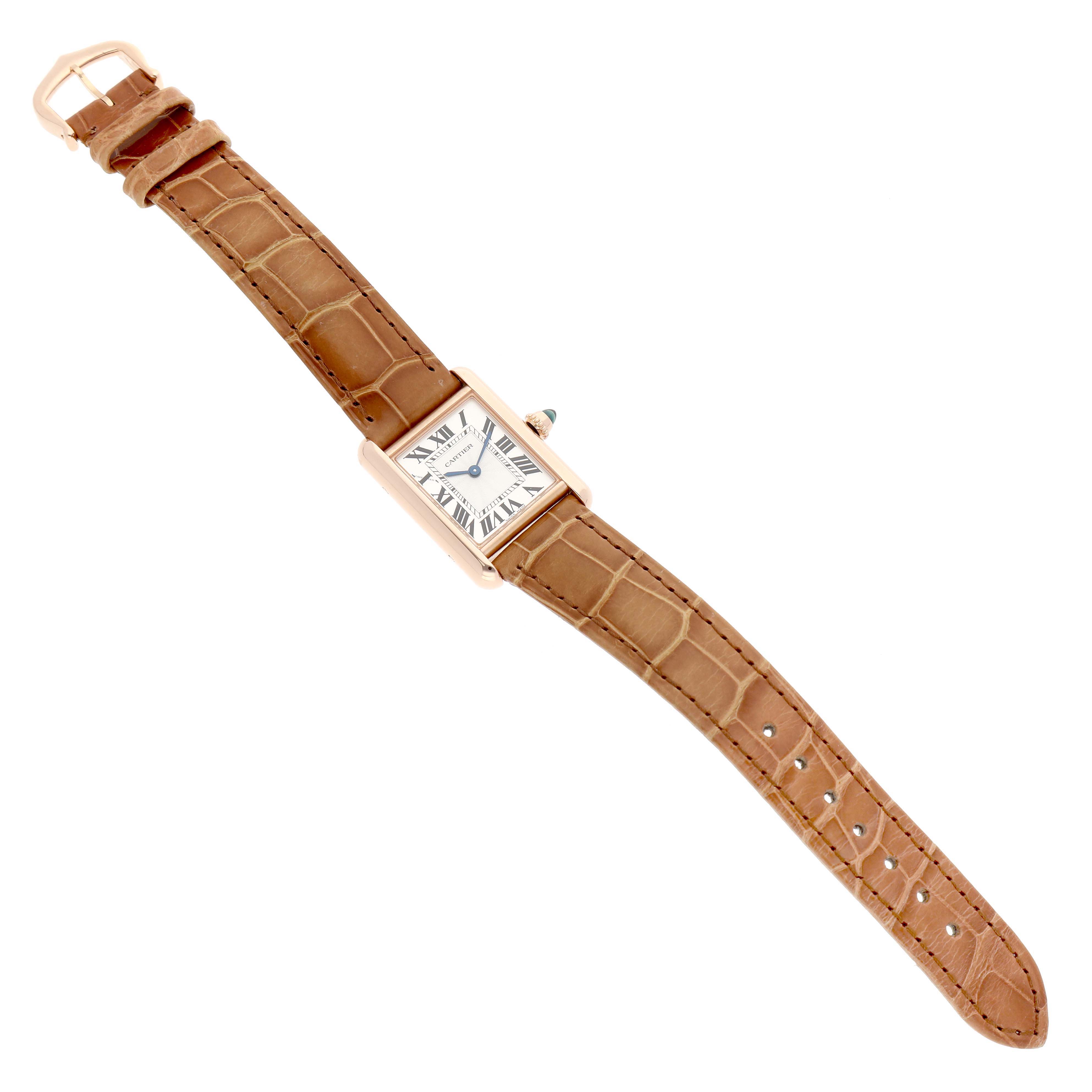 The Cartier Tank Louis WGTA0010 Women's Rose Gold Silver Dial watch is shown from a top-down angle, displaying its rectangular face and entire brown leather strap.