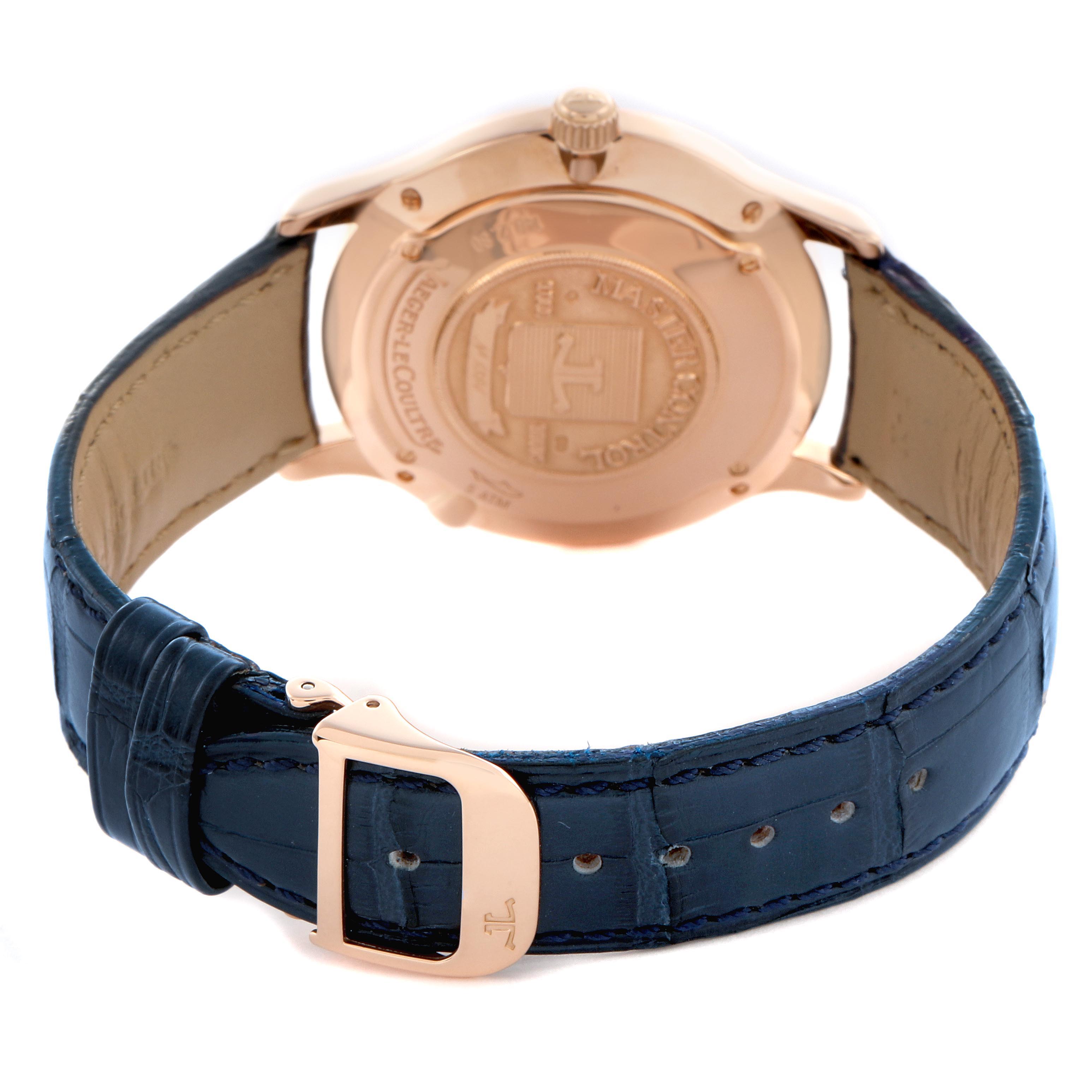 The image shows the Jaeger LeCoultre Master Q149242A Men
s Rose Gold Silver Dial Q149242A Men
s Rose Gold Silver Dial model from the back, highlighting the case back, crown, and blue leather strap with buckle.